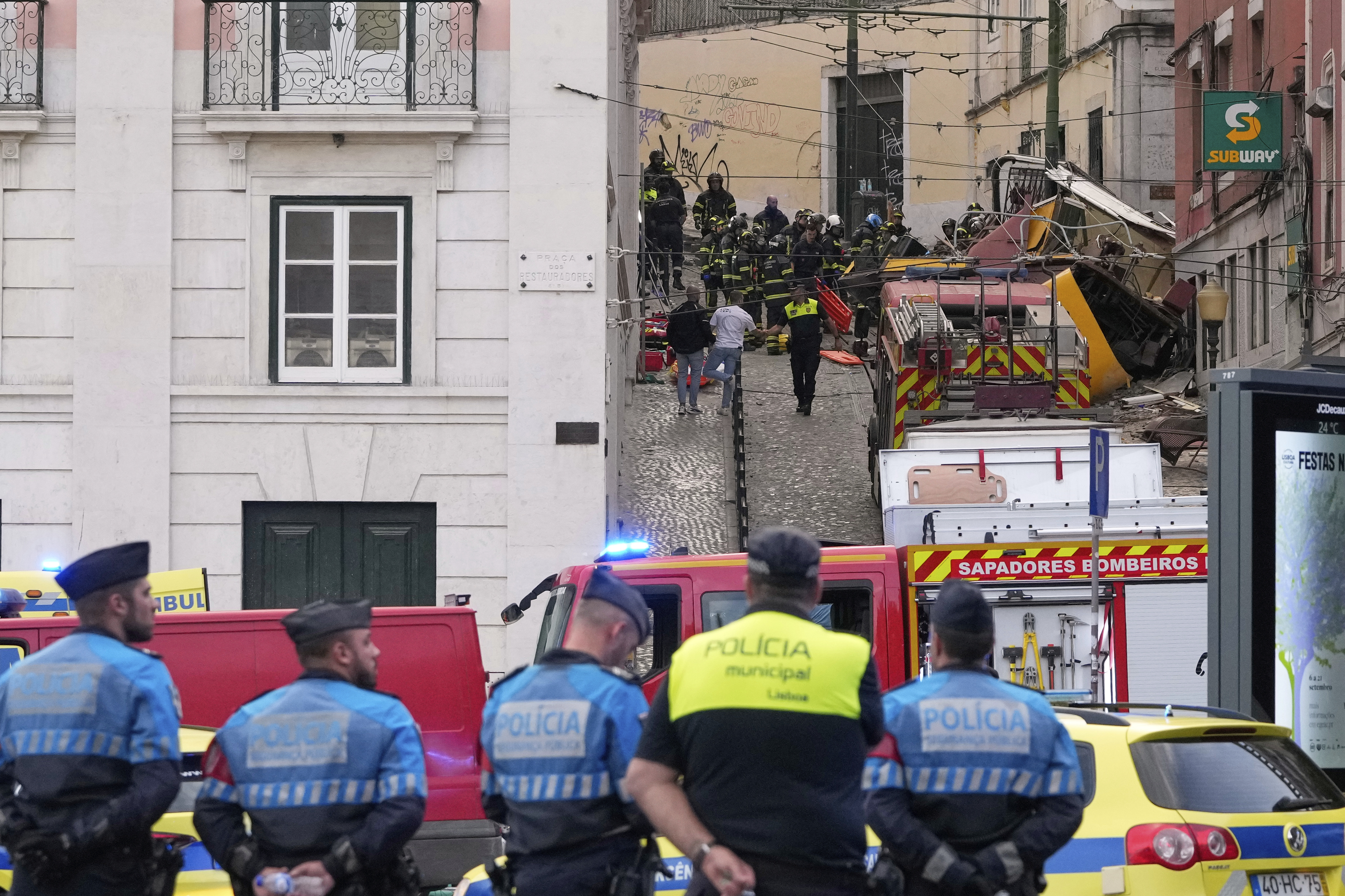 Emergency teams work at the site of a derailed electric streetcar in Lisbon, Portugal, Wednesday, Sept. 3, 2025. (AP Photo/Armando Franca)
