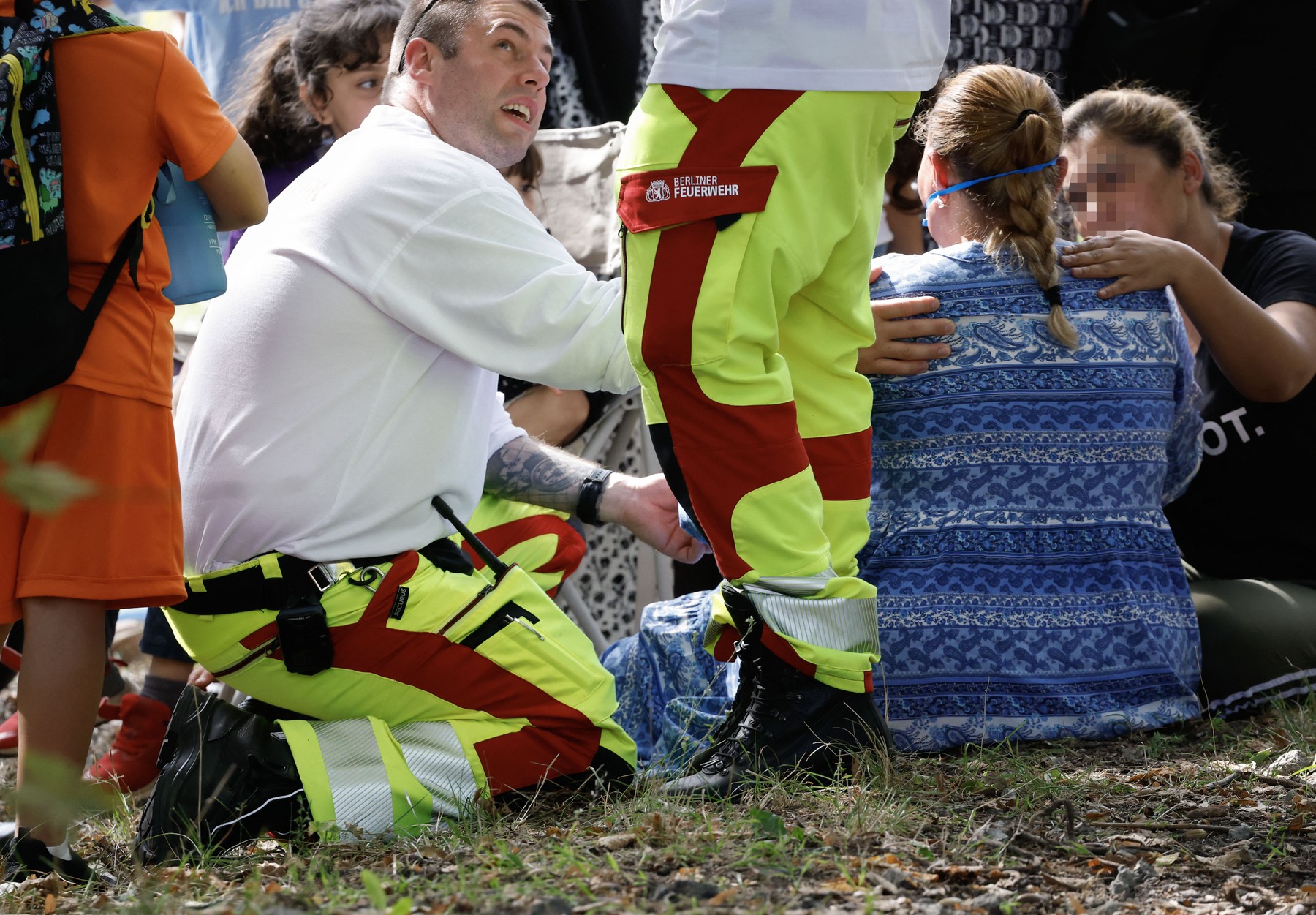 Emergency personnel comfort shocked witnesses after a car accidentally