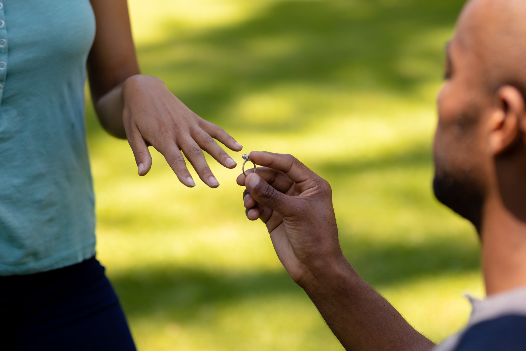 Side view close up of an African American man kneeling in the garden