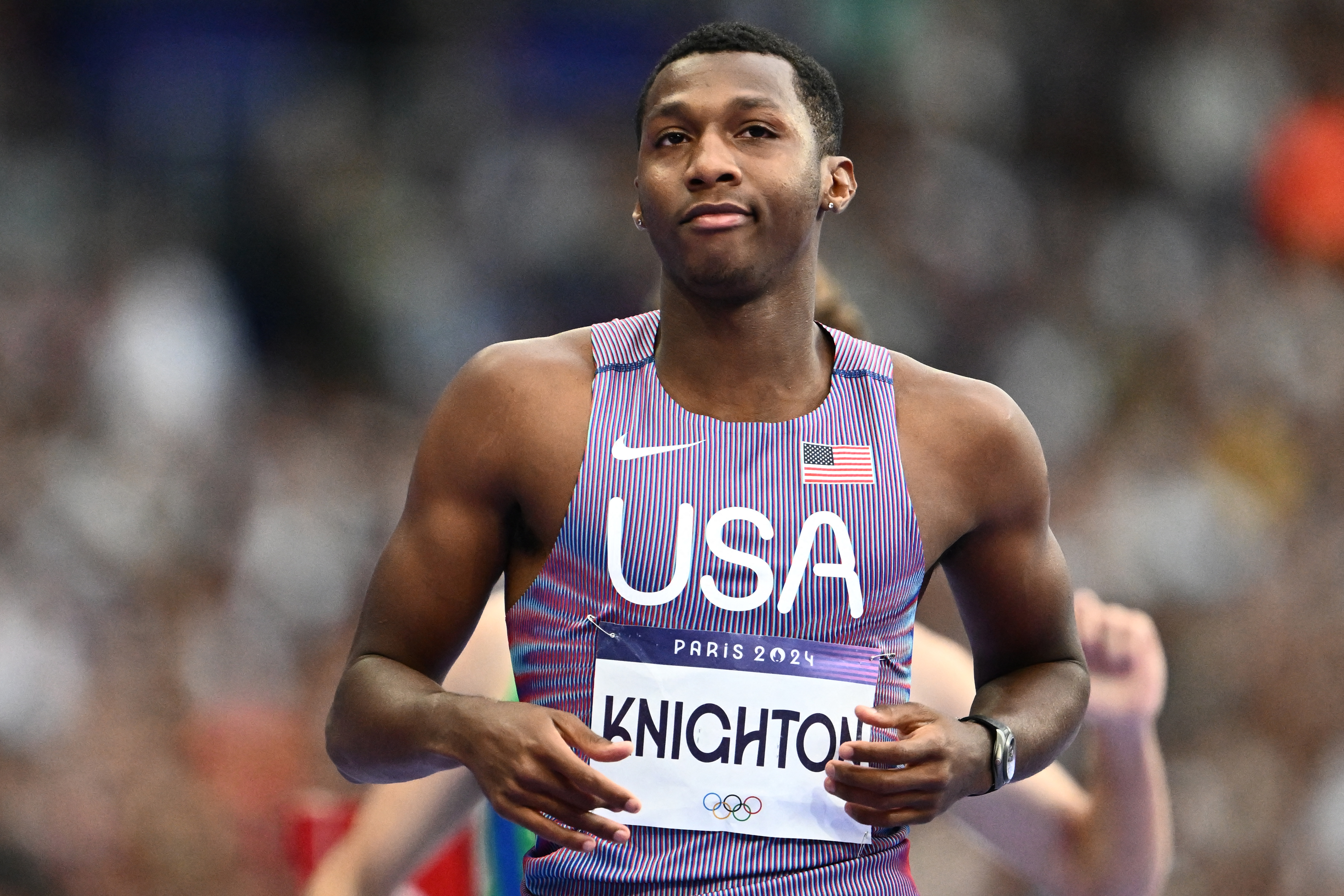 US' Erriyon Knighton reacts after competing in the men's 200m semi-final of the athletics event at the Paris 2024 Olympic Games at Stade de France in Saint-Denis, north of Paris, on August 7, 2024. (Photo by Jewel SAMAD / AFP)