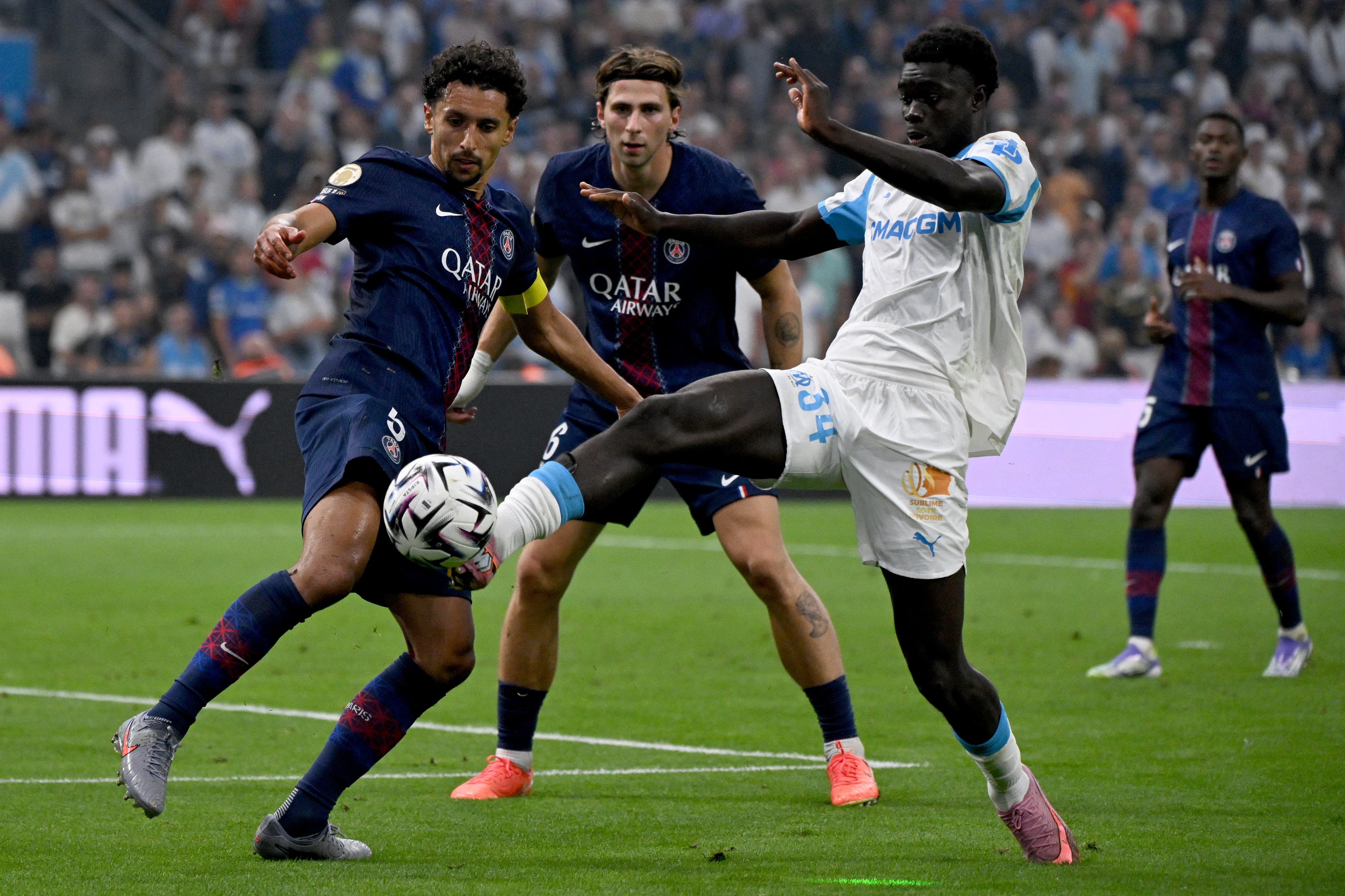Marseille's French forward #34 Robinio Vaz (R) vies with Paris Saint-Germain's Brazilian defender #05 Marquinhos
