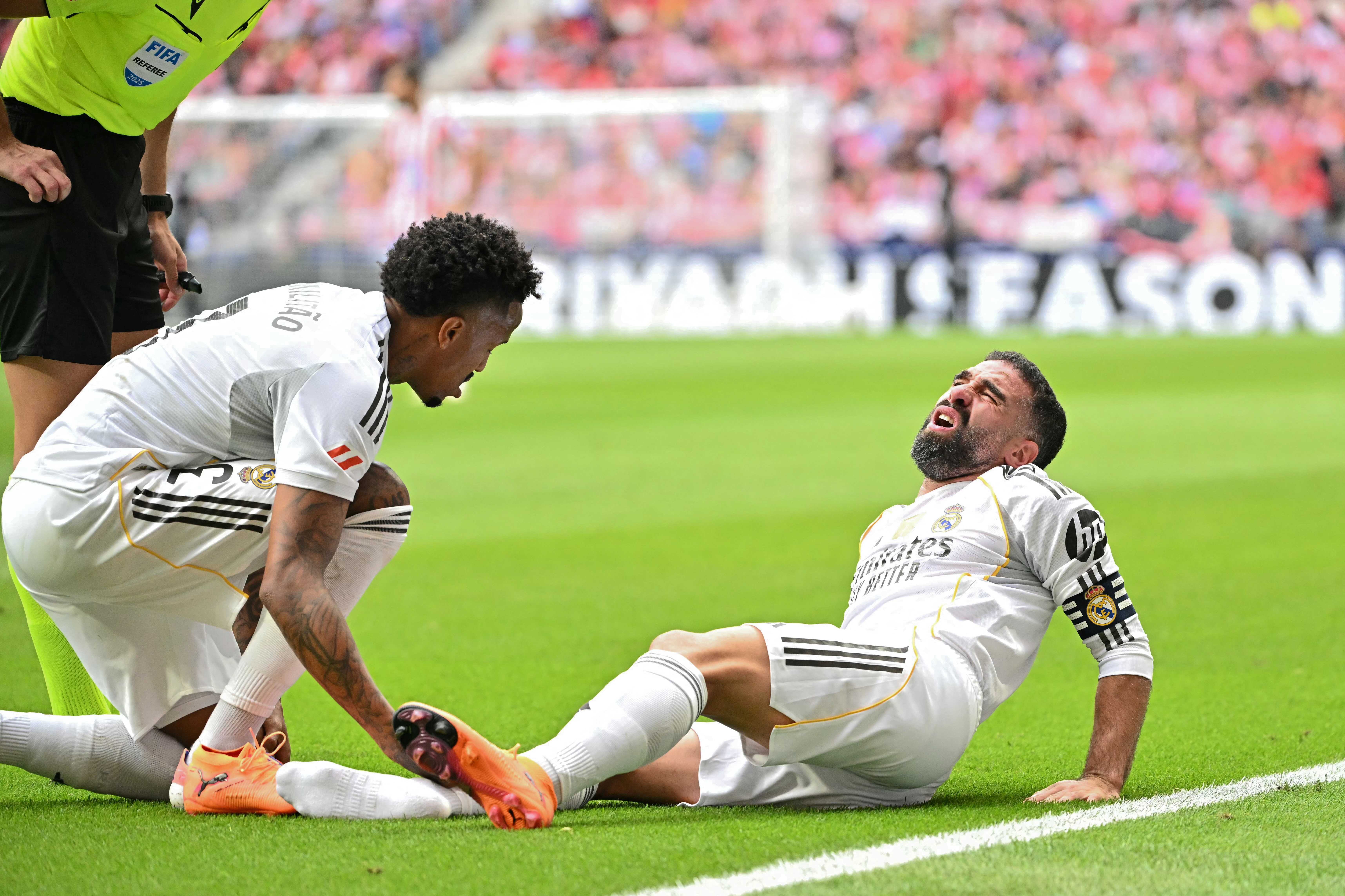 Real Madrid's Spanish defender #02 Dani Carvajal reacts on the ground during the Spanish league football match between Club Atletico de Madrid and Real Madrid CF at the Metropolitano stadium in Madrid on September 27, 2025. (Photo by Javier SORIANO / AFP)