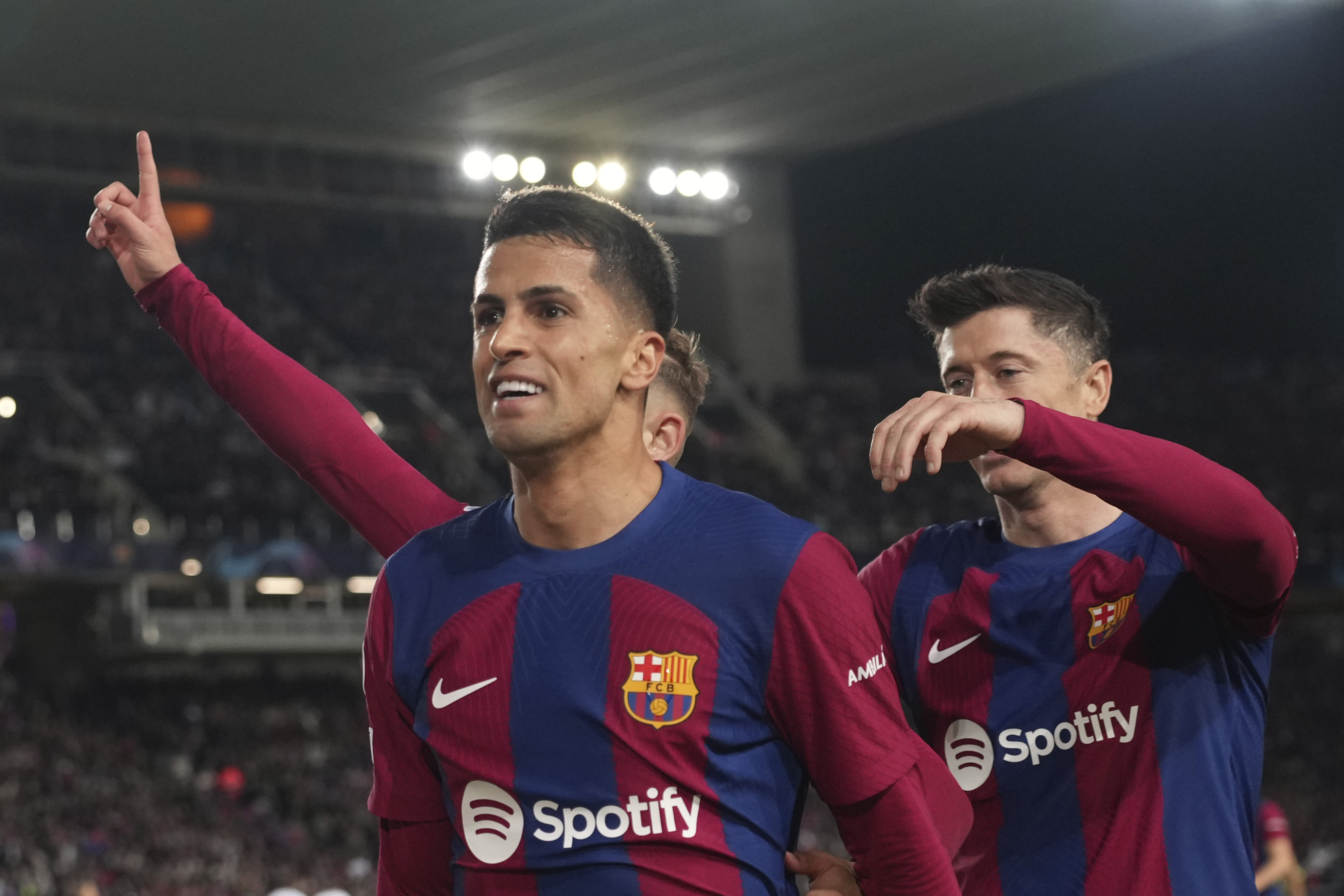 Barcelona's Joao Cancelo celebrates after scoring his side's second goal during the Champions League, round of 16, second leg soccer match between Barcelona and SSC Napoli at the Olympic Lluis Companys stadium in Barcelona, Spain, Tuesday, March 12, 2024.