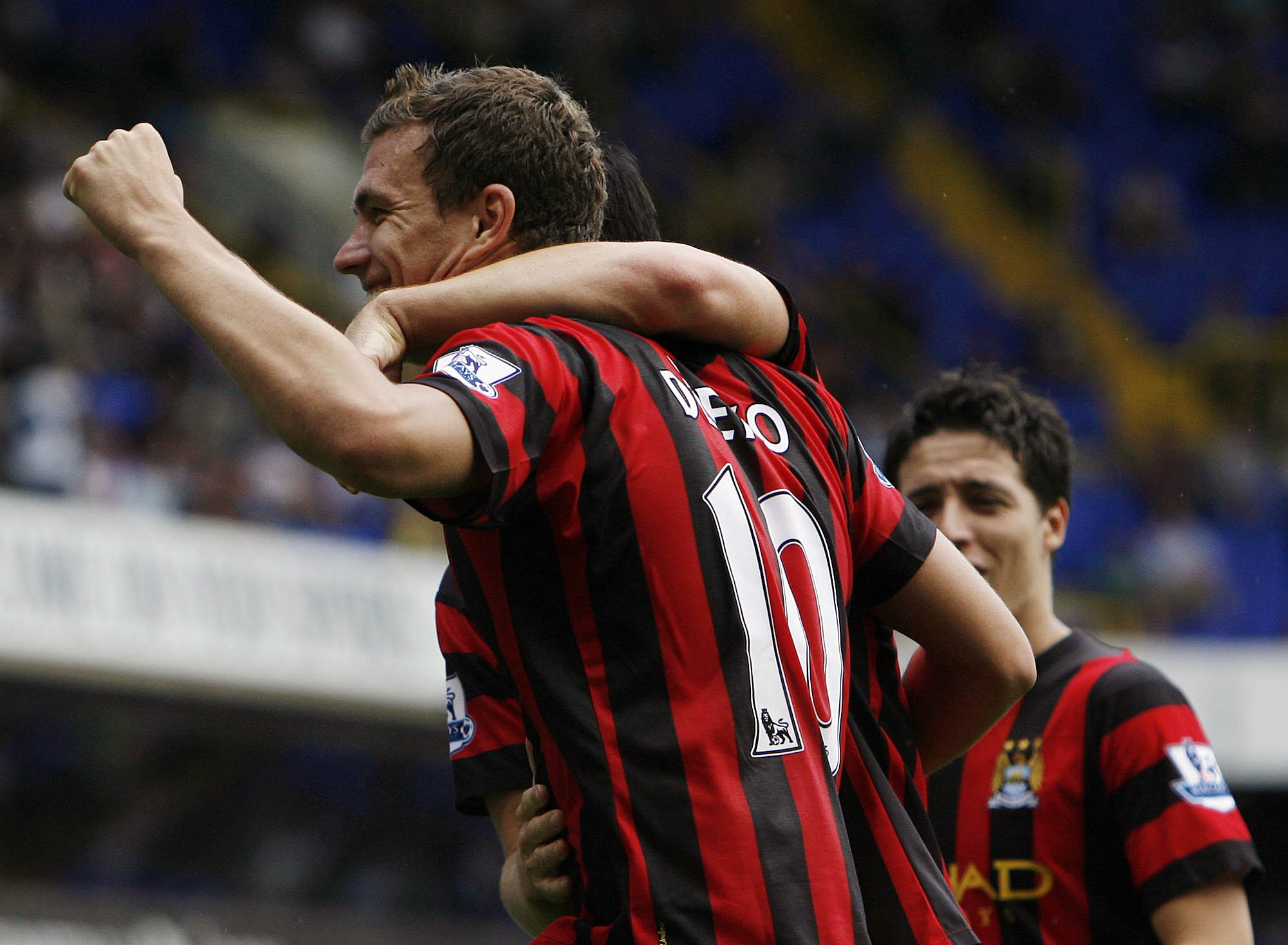 Manchester City's Edin Dzeko, front left, celebrates scoring his 4th goal against Tottenham Hotspur with Manchester City's Samir Nasri, rear right, during the English Premier League soccer match between Tottenham Hotspur and Manchester City at White Hart