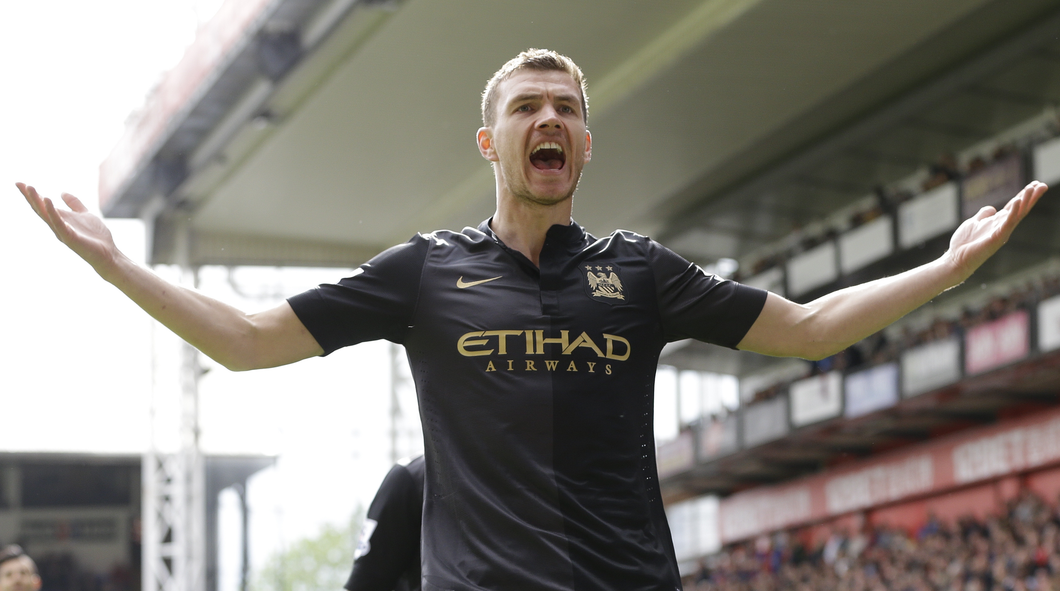 Manchester City's  Edin Dzeko celebrates after he scores a goal during the English Premier League soccer match between Crystal Palace and Manchester City at Selhurst Park stadium in London, Sunday, April 27, 2014. (AP Photo/Kirsty Wigglesworth)