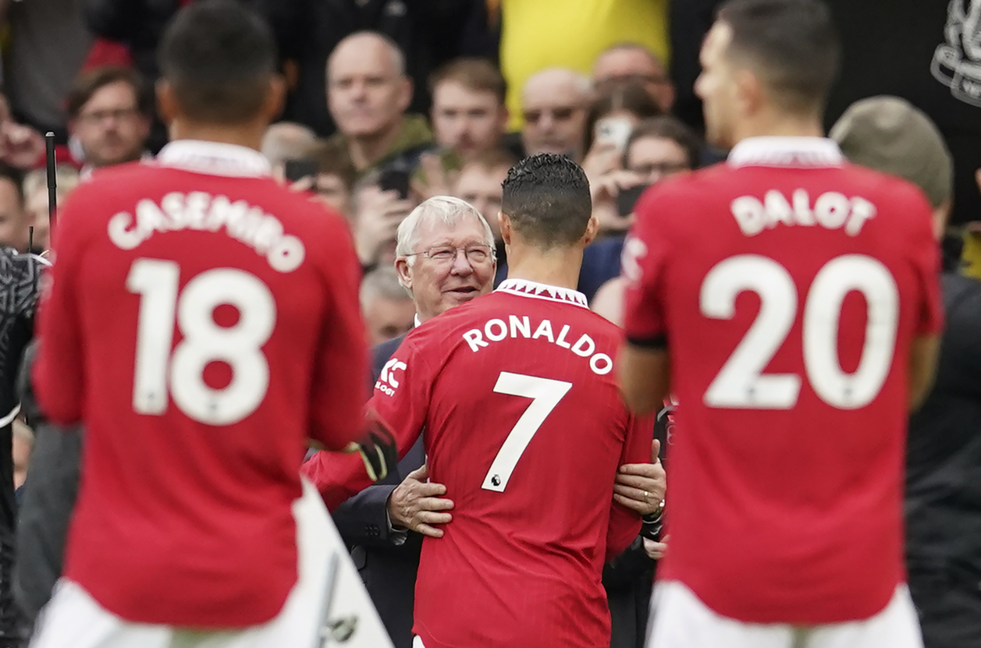 Former Manchester United manager Sir Alex Ferguson, centre, greets Manchester United's Cristiano Ronaldo prior the English Premier League soccer match between Manchester United and Newcastle at Old Trafford stadium in Manchester, England, Sunday, Oct. 16,