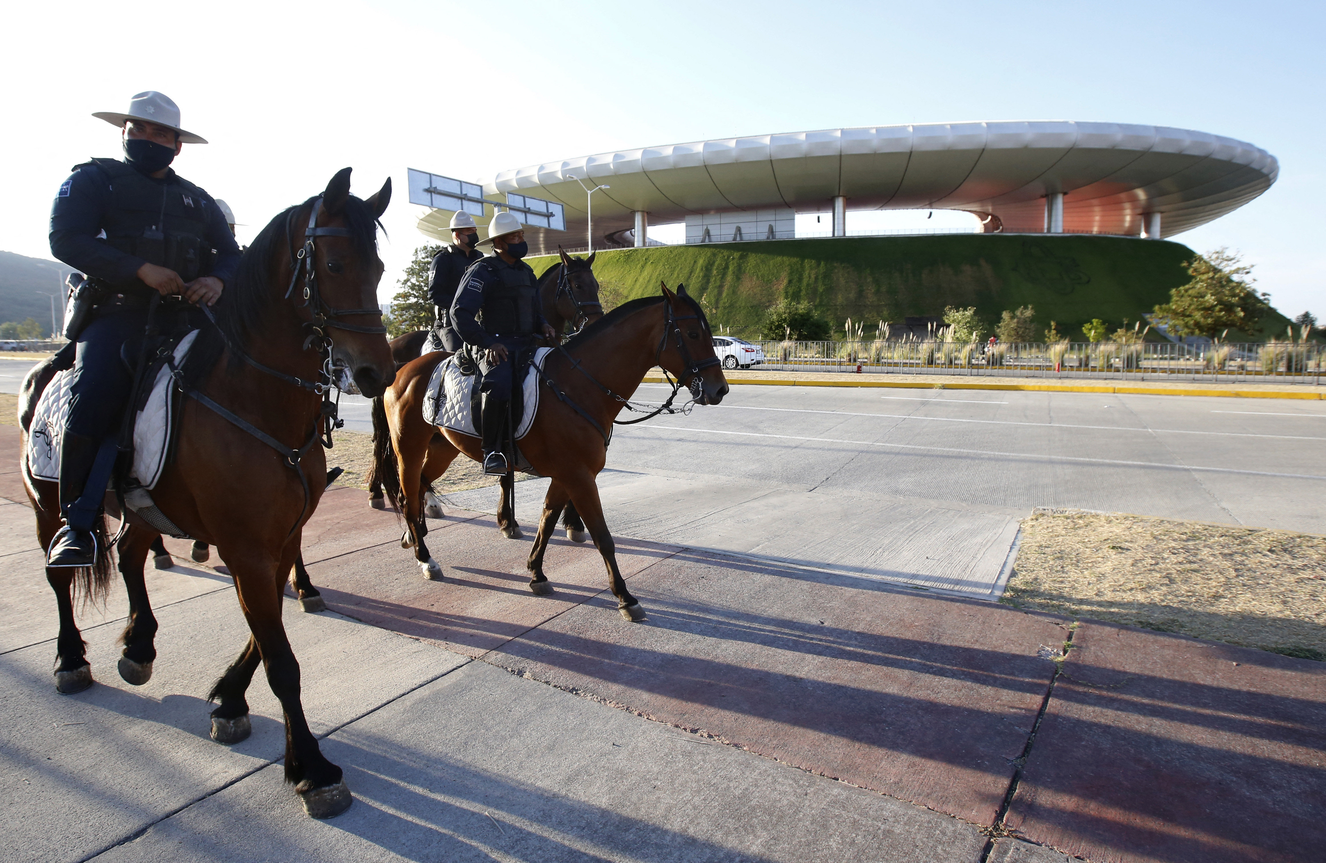 Mounted police officers patrol outside the Akron stadium before the start of the
