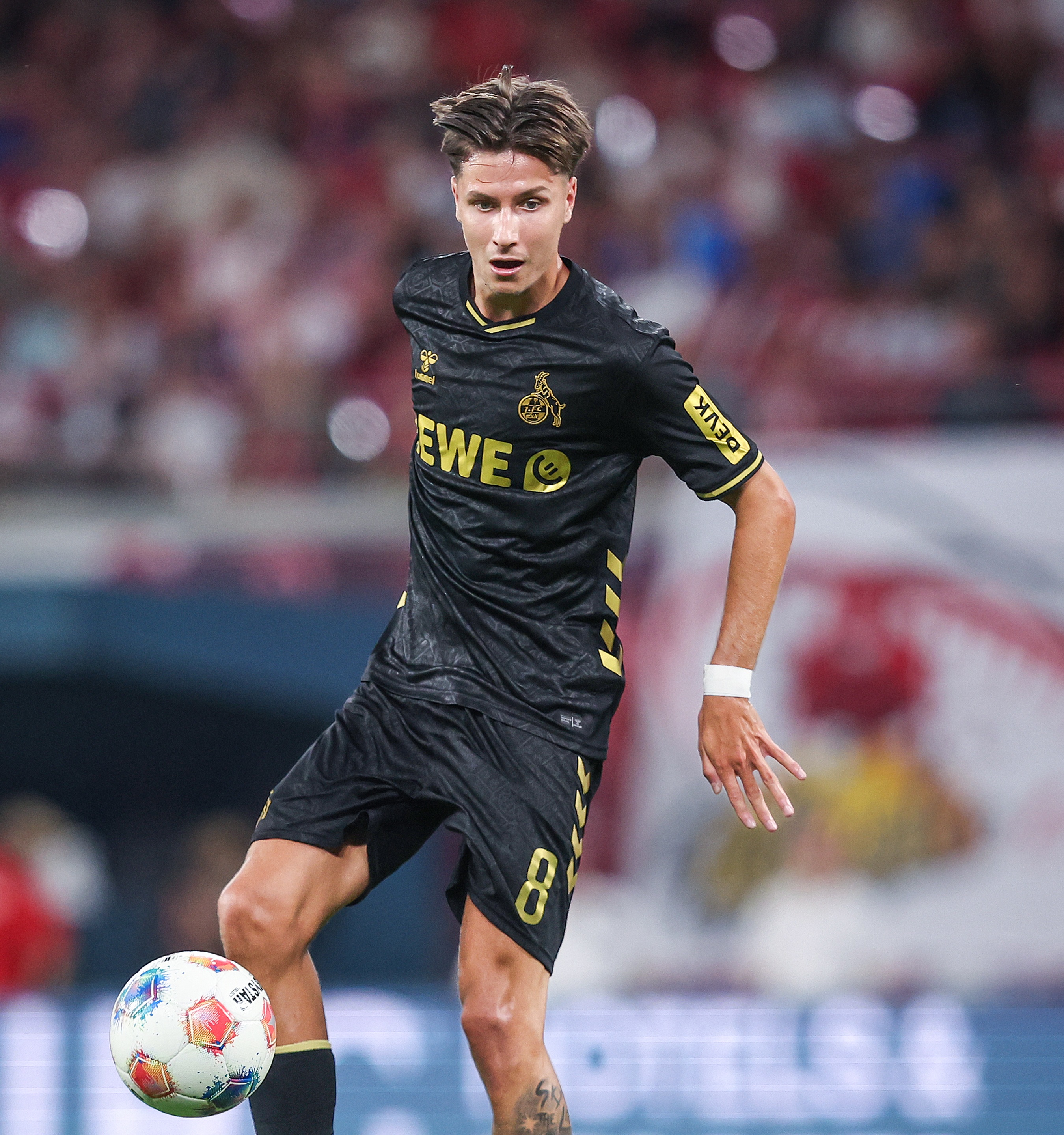 FC Cologne's Bosnian midfielder #08 Denis Huseinbasic plays the ball during the German first division Bundesliga football match RB Leipzig v FC Cologne v in Leipzig, eastern Germany on September 20, 2025. (Photo by Ronny Hartmann / AFP)
