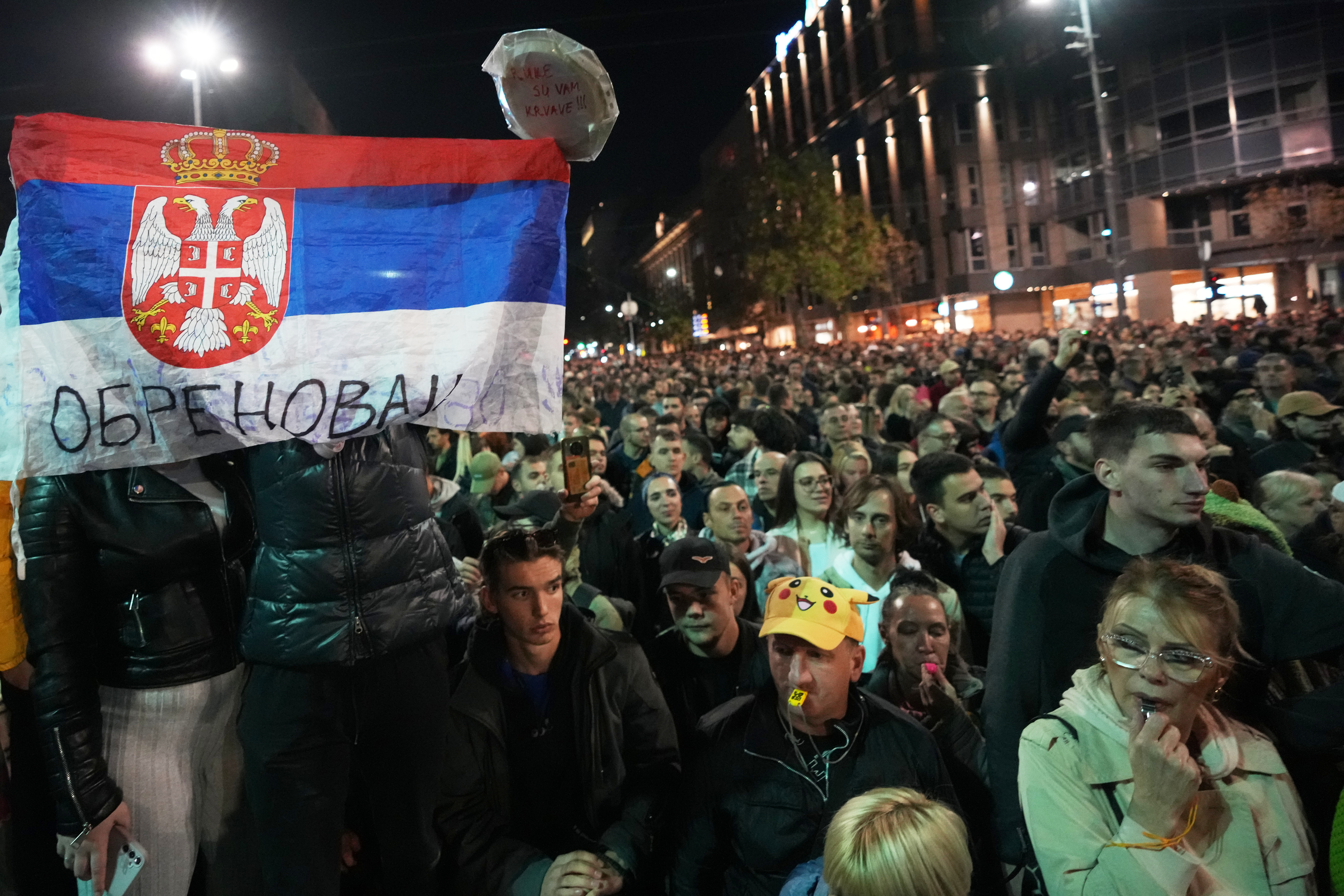 Opponents of Serbia's President Aleksandar Vucic attend a protest in front of the parliament building, in Belgrade, Serbia, Wednesday, Nov. 5, 2025. (AP Photo/Darko Vojinovic)