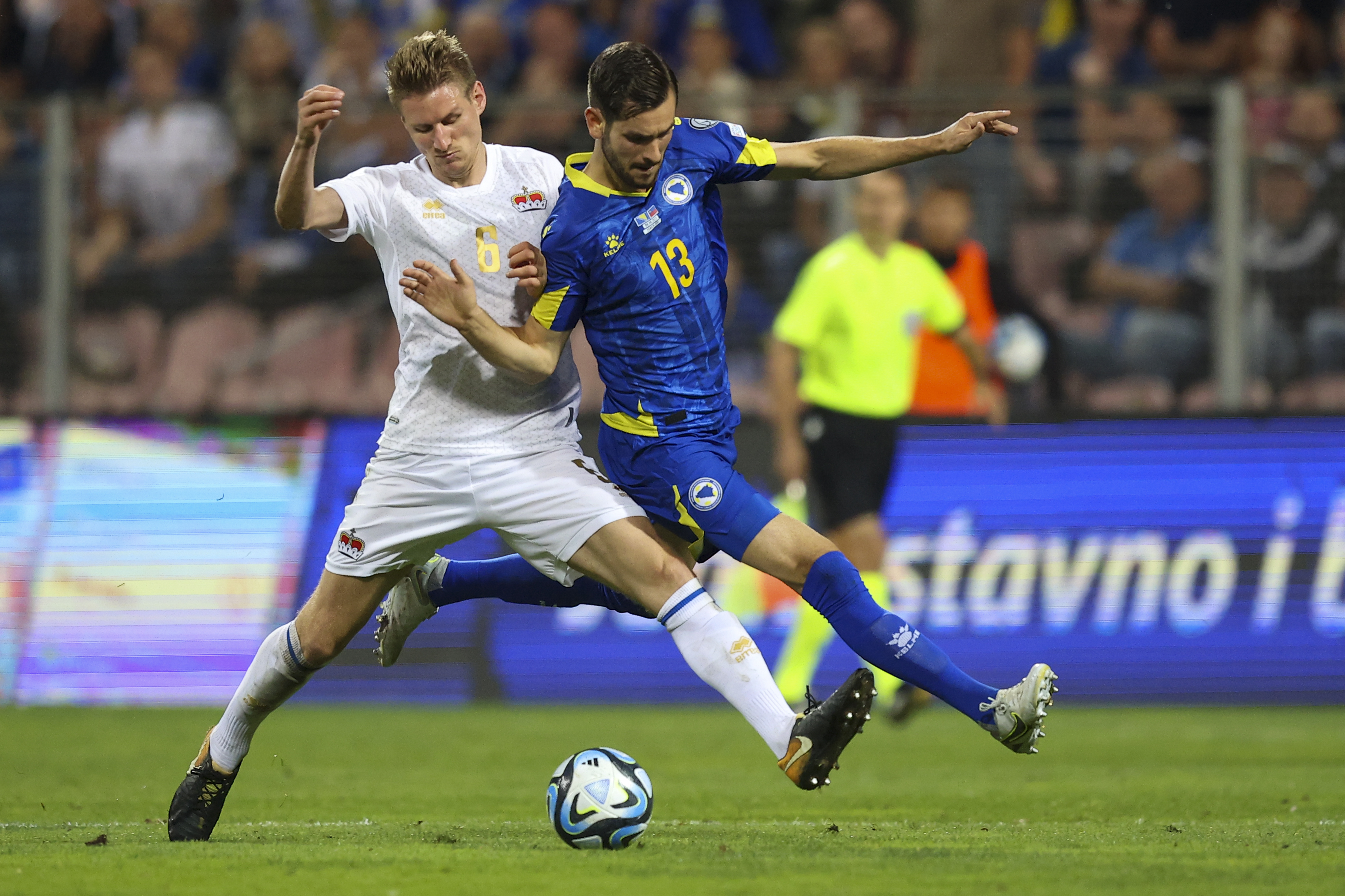 Bosnia's Adi Nalic, right, duels for the ball with Liechtenstein's Andreas Malin during the Euro 2024 group J qualifying soccer match between Bosnia-Herzegovina and Liechtenstein, at the Bilino Polje Stadium in Zenica, Bosnia and Herzegovina, Friday, Sept