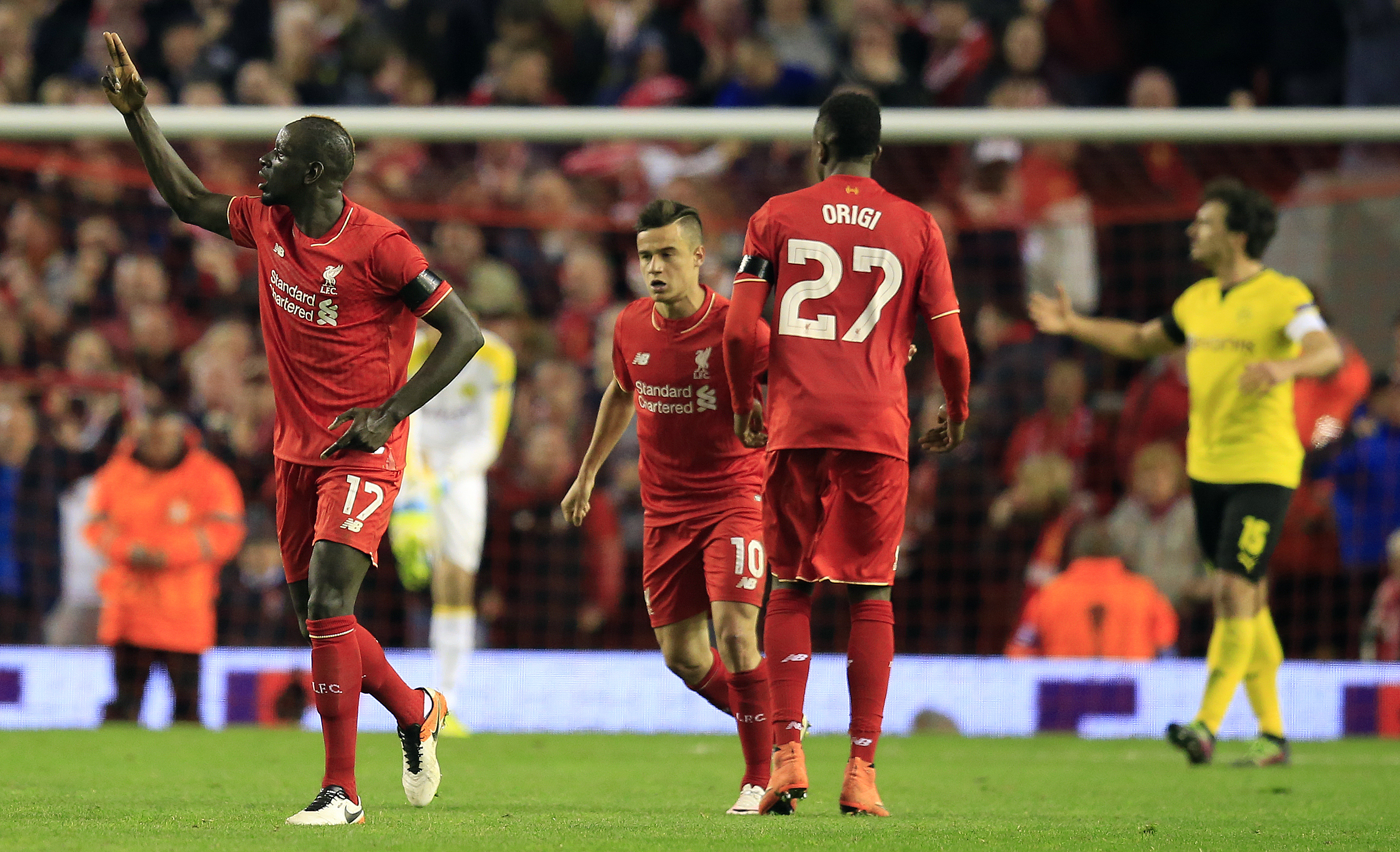Liverpool's Mamadou Sakho, left, celebrates after scoring during the Europa League quarterfinal second leg soccer match between Liverpool  FC and Borussia Dortmund in Liverpool, England, Thursday, April 14, 2016 . (AP Photo/Jon Super)