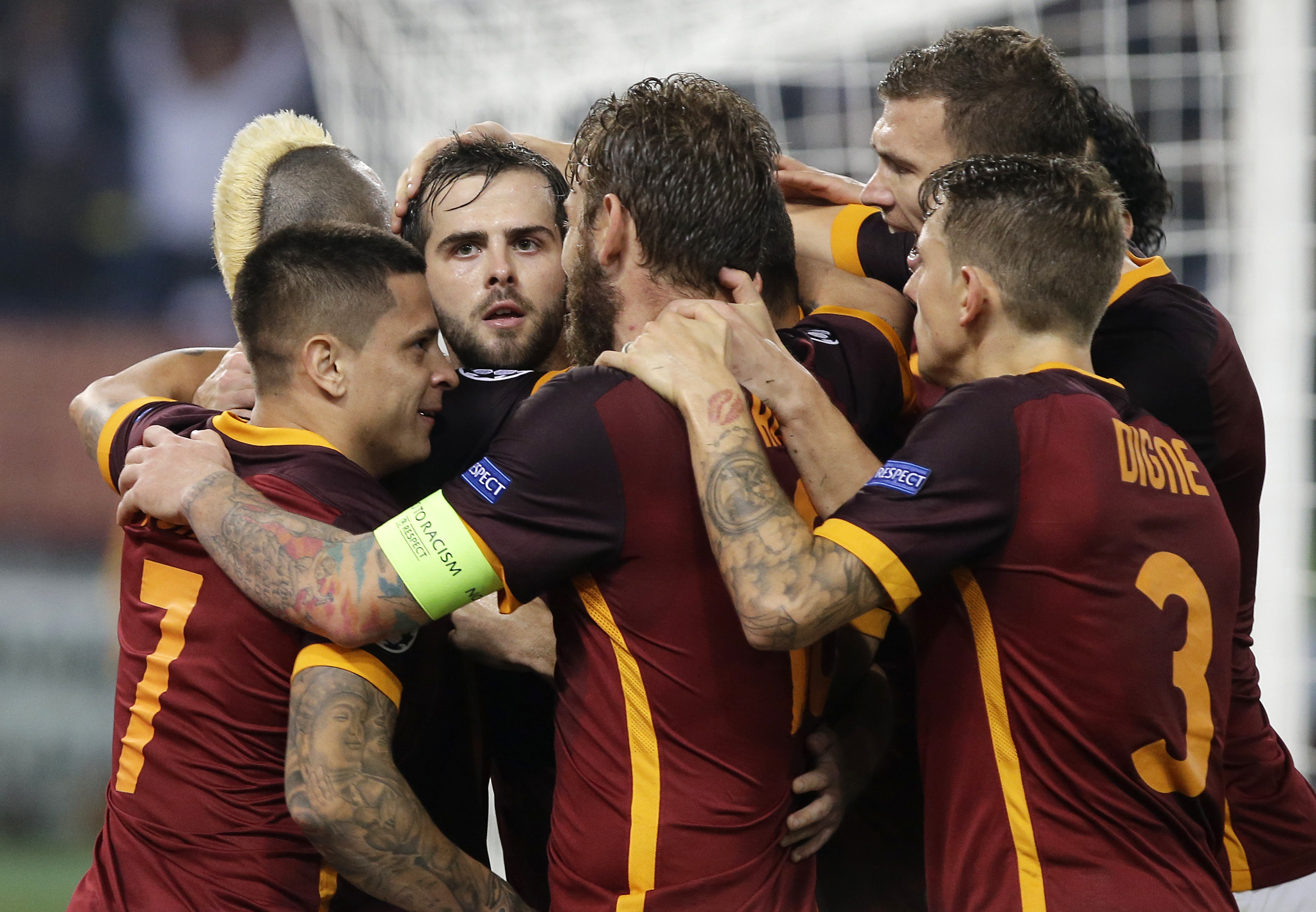 Roma’s Miralem Pjanic, third from left, celebrates with his teammates after scoring during the Champions League group E soccer match between Roma and Bayer Leverkusen at the Olympic stadium, in Rome, Italy, Wednesday, Nov. 4, 2015. Pjanić Džeko