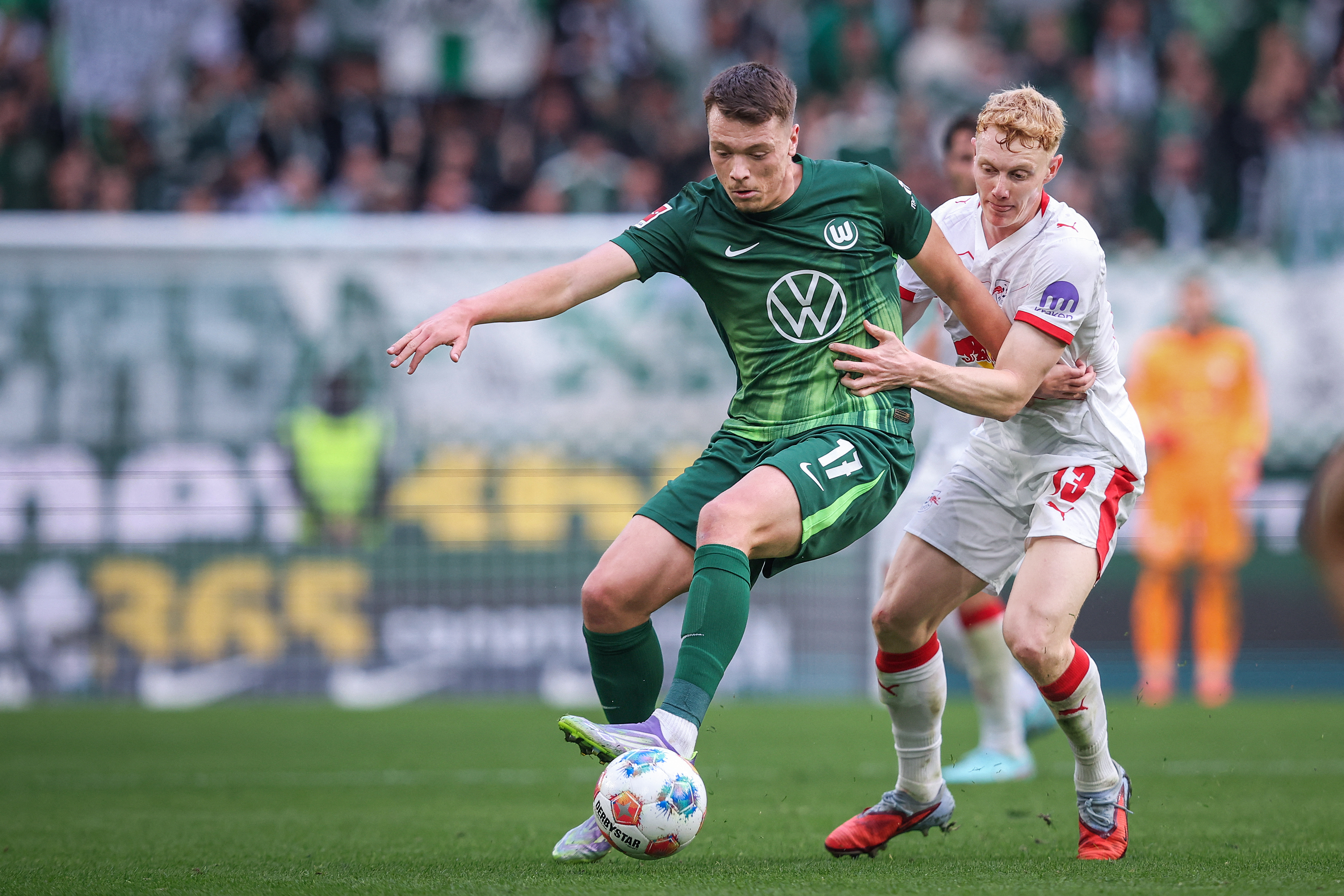 Wolfsburg's German forward #17 Dzenan Pejcinovic (L) and Leipzig's Austrian midfielder #13 Nicolas Seiwald vie for the ball during the German first division Bundesliga football match between VfL Wolfsburg and RB Leipzig in Wolfsburg, northern Germany on S