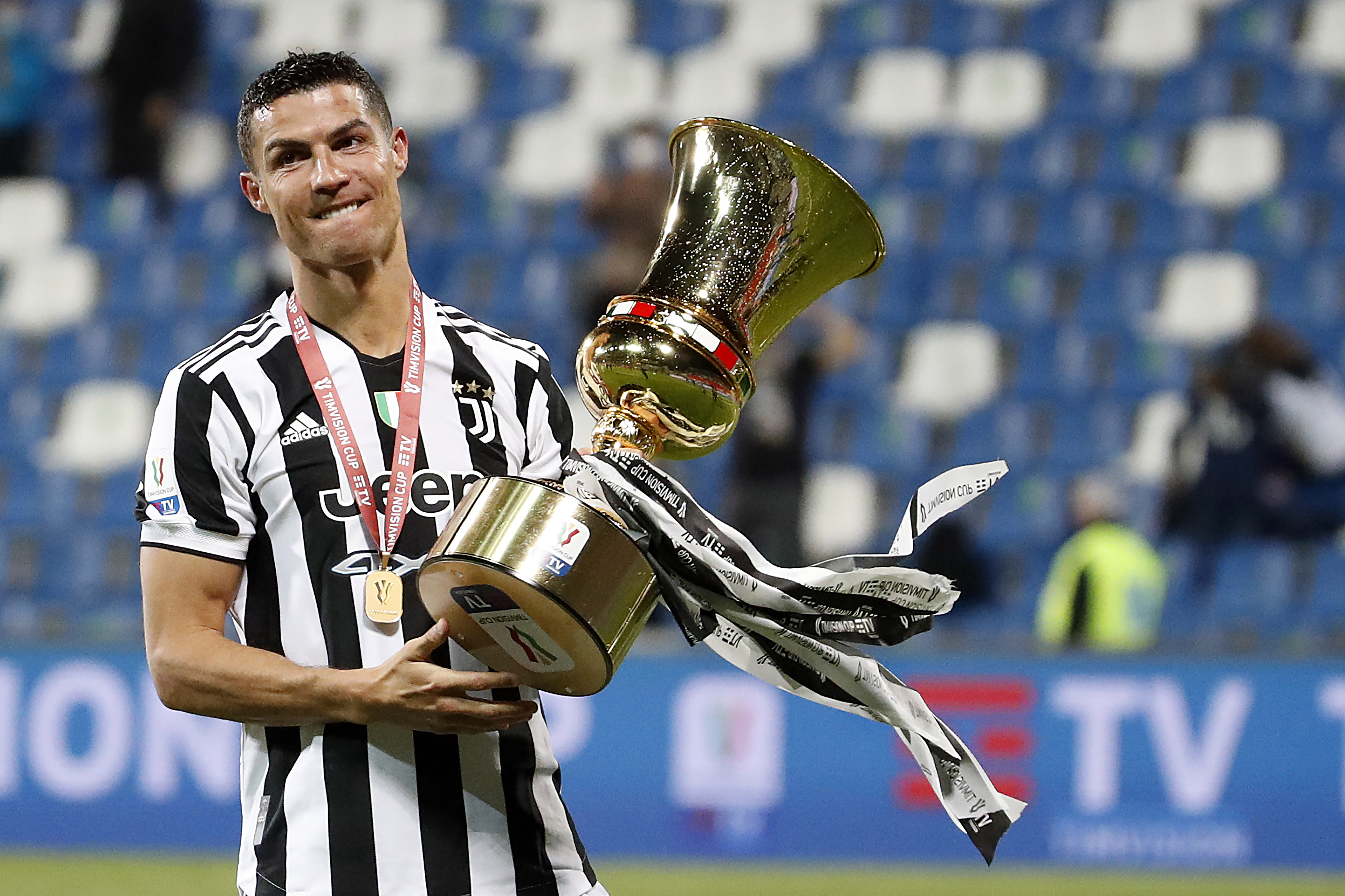 FILE - Juventus' Cristiano Ronaldo celebrates with the winner's trophy a victory against Atalanta after the end of Italian Cup soccer final match between Atalanta and Juventus at the Mapei Stadium in Reggio Emilia, Italy, Wednesday, May 19, 2021. (AP Phot