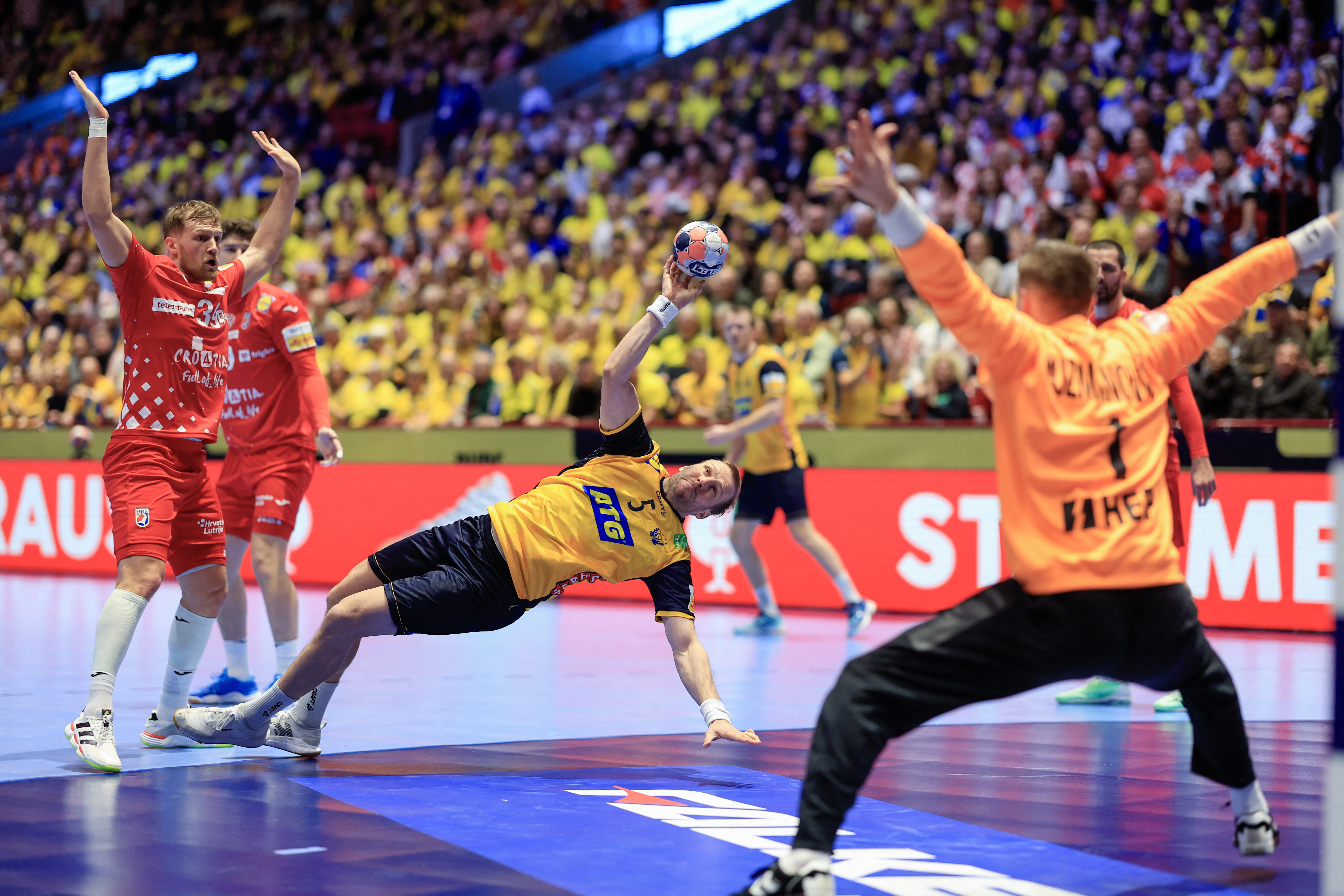 Sweden's pivot #05 Max Darj (C) scores during the men's EHF Euro 2026 Group E preliminary round handball match between Sweden and Croatia in Malmo, Sweden, on January 21, 2026. (Photo by Andreas Hillergren/TT / TT News Agency / AFP) / Sweden OUT