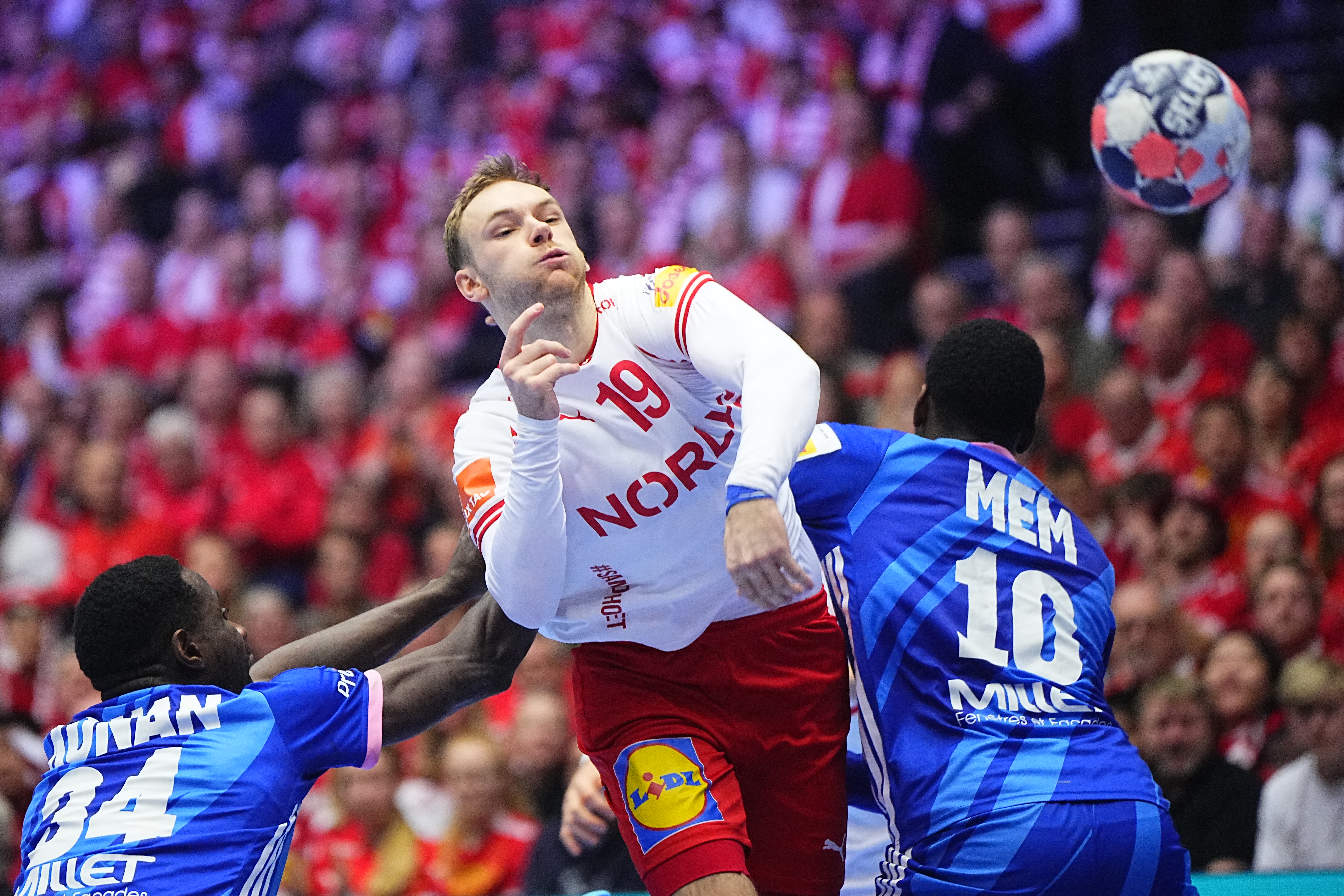 Denmark's right back #19 Mathias Gidsel (C) shoots the ball during the UEFA