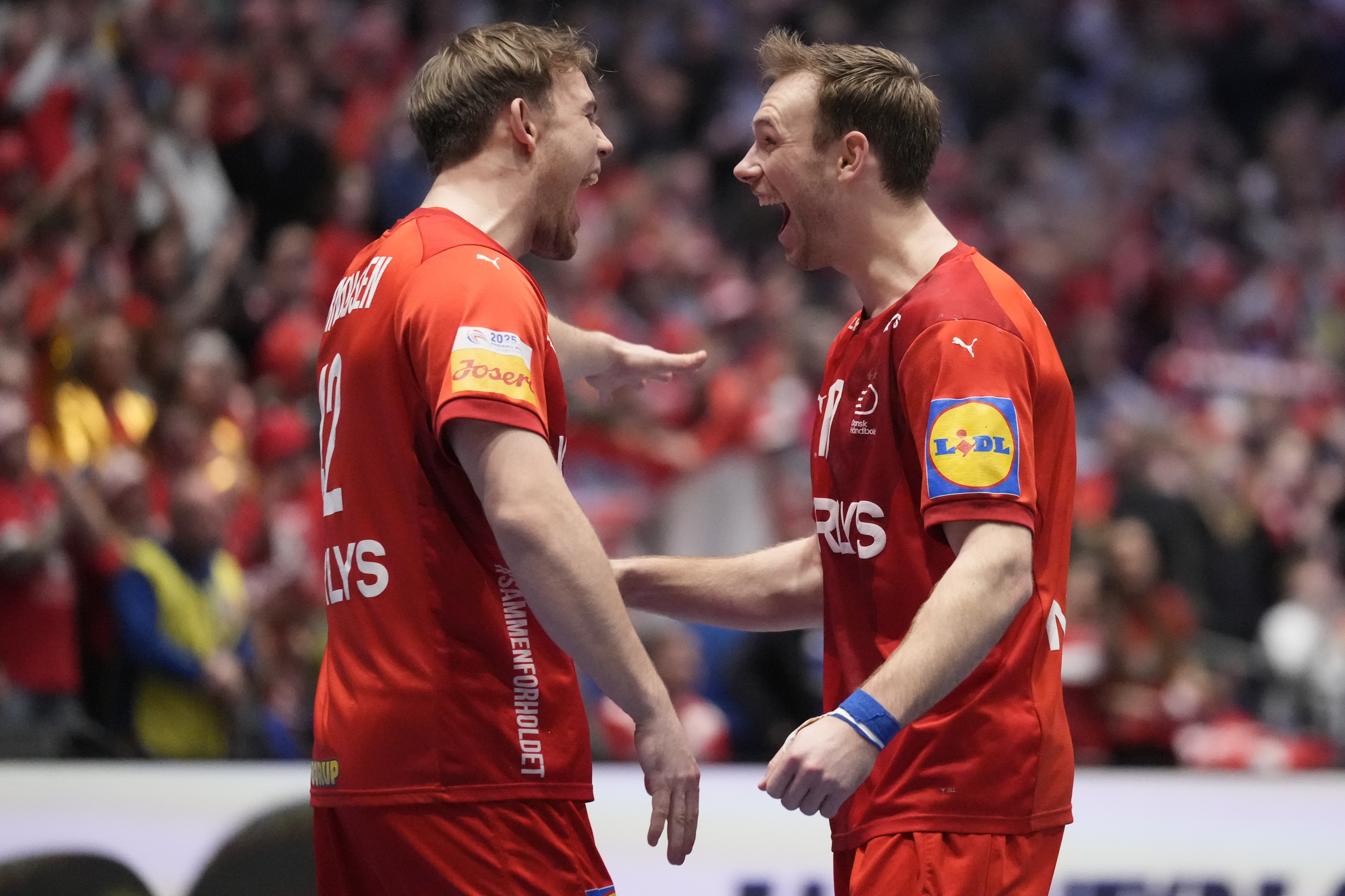 Denmark's Mads Mensah Larsen, left, and Mathias Gidsel celebrate after the final match between Denmark and Croatia at the Handball Men's World Championships in Oslo, Norway, Sunday, Feb. 2, 2025. (AP Photo/Darko Bandic)