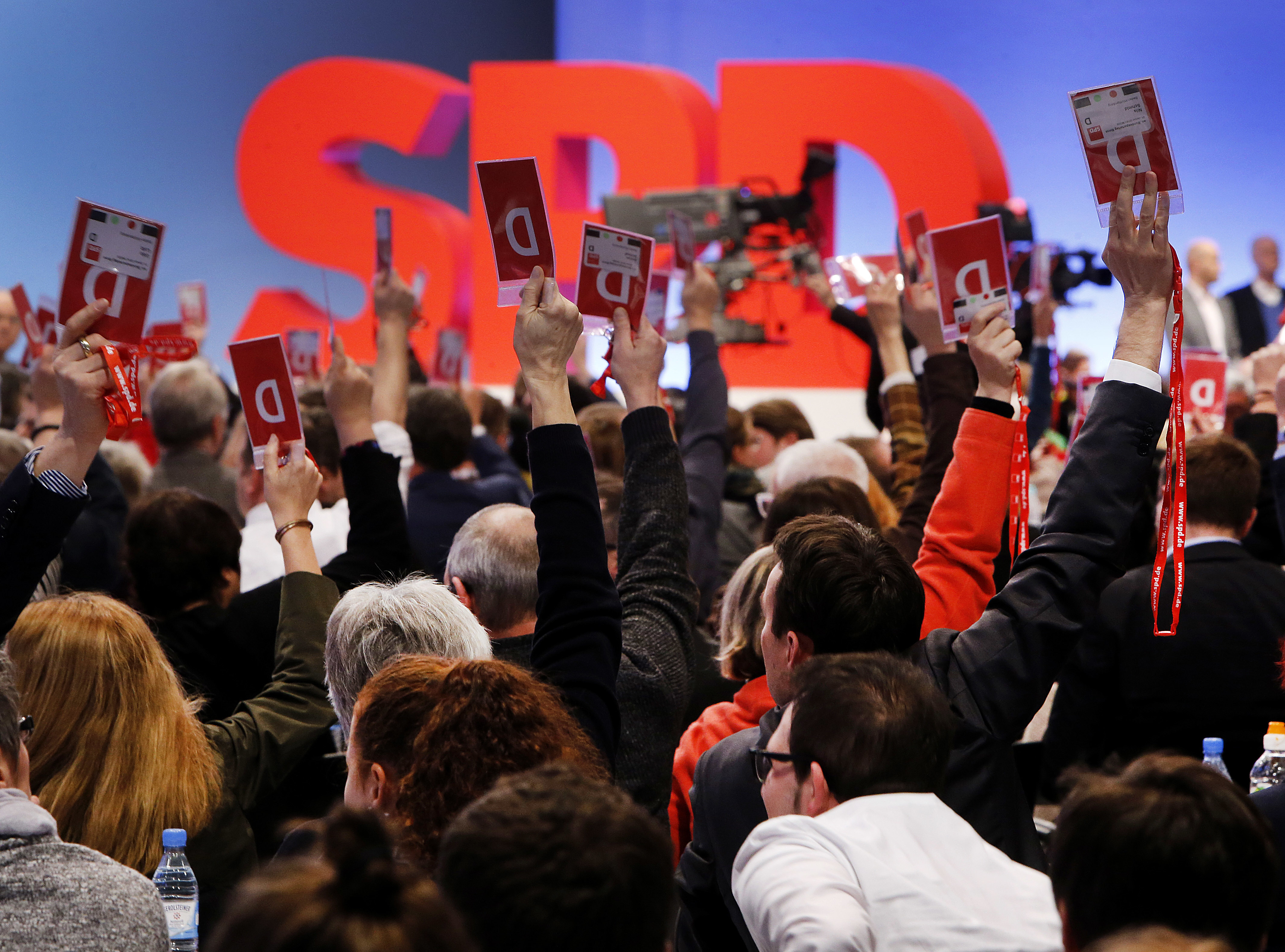 Delegates vote for coalition talks with Chancellor Angela Merkel's conservatives during a party meeting of the Social Democrats, SPD, in Bonn, Germany, Sunday, Jan. 21, 2018. (AP Photo/Michael Probst)