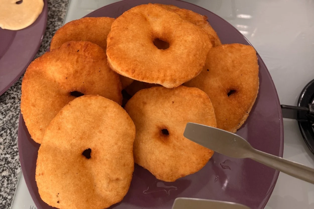 Plate of golden-brown fried donuts arranged neatly, photographed on October 21, 2026.
