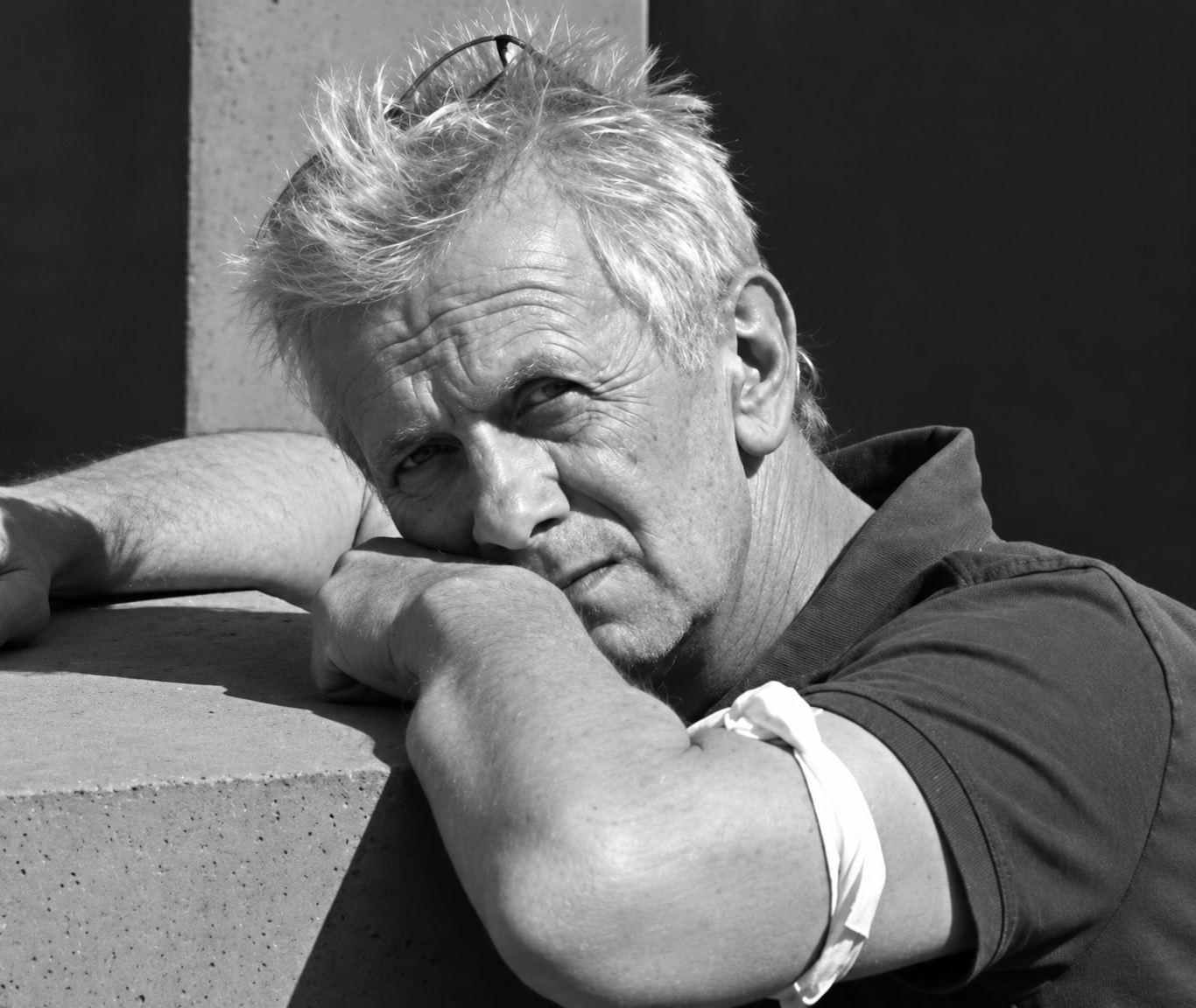 Contemplative Man Resting on Concrete