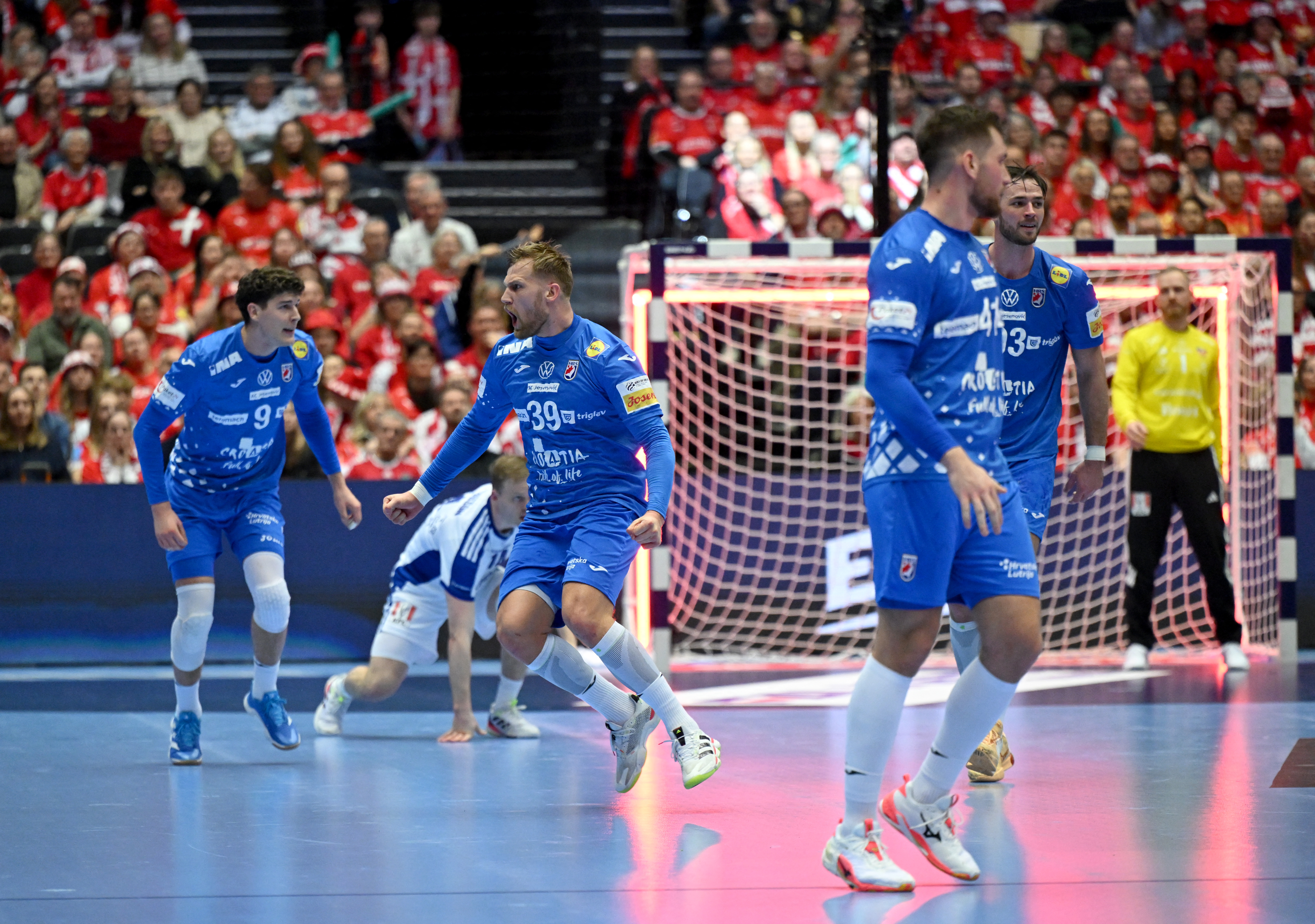 Croatia's wing #39 David Mandic (2nd L) celebrates a goal during the men's EHF Euro 2026 third place handball match Iceland vs Croatia in Herning, Denmark, on February 1, 2026. (Photo by Jonathan Nackstrand / AFP)