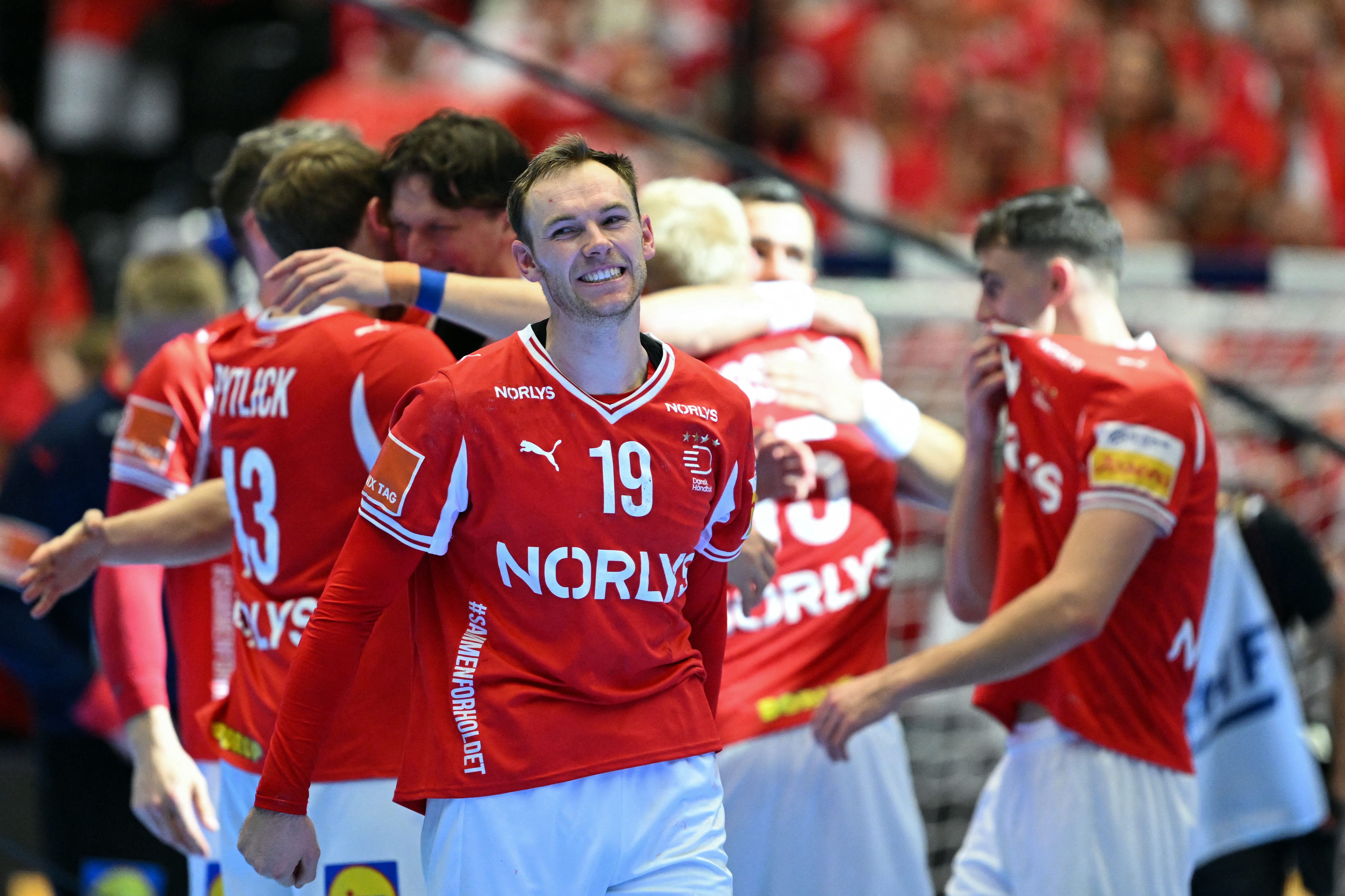Denmark's right back #19 Mathias Gidsel and team mates celebrate after winning the Men's EHF Euro 2026 final handball match Denmark vs Germany in Herning, Denmark, on February 1, 2026. Denmark won the match 34-27. (Photo by Jonathan Nackstrand / AFP)