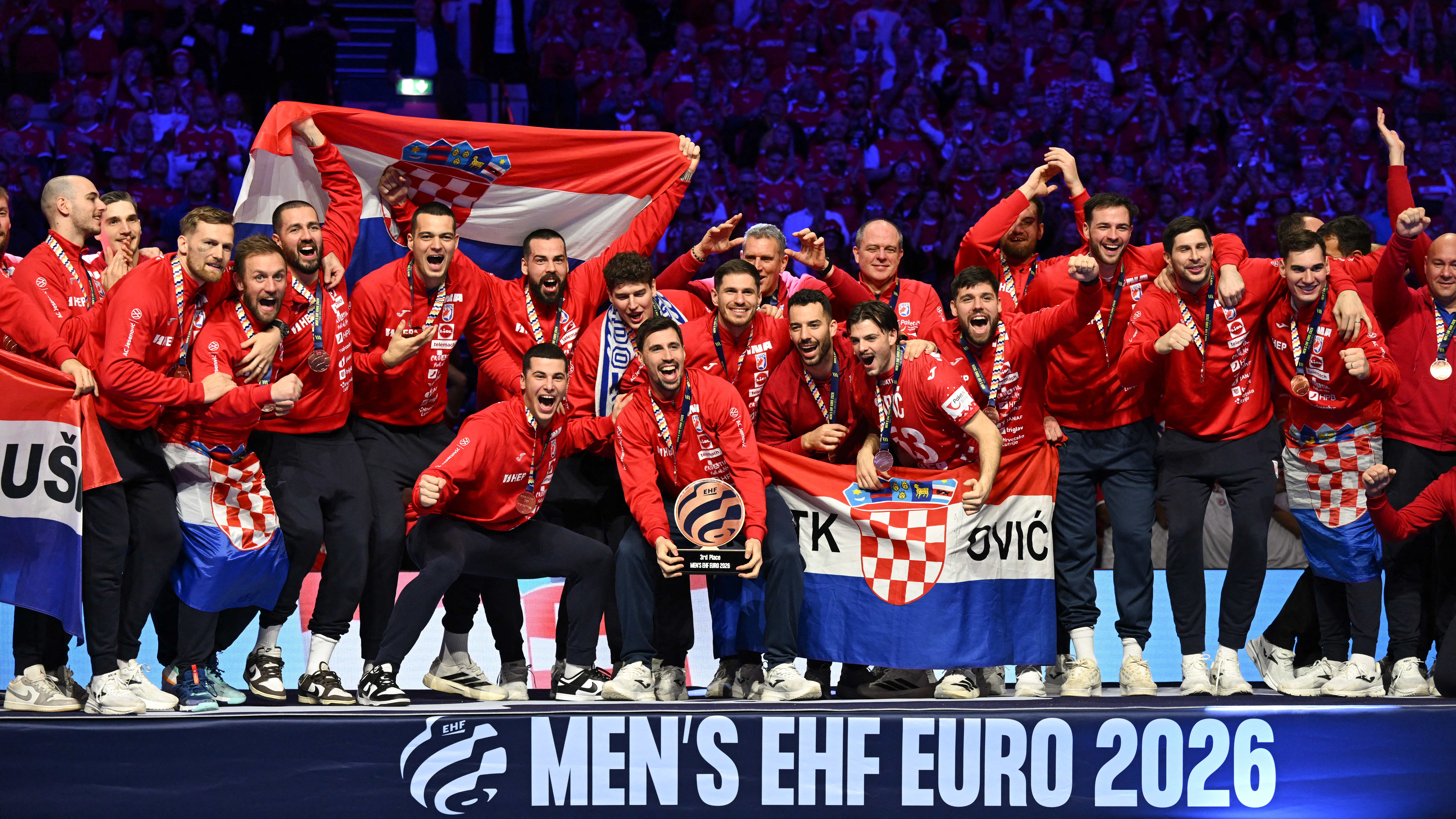 Croatia's players celebrate with the trophy during the awarding ceremony after the team won bronze in the Men's EHF Euro 2026 finals in Herning, Denmark, on February 1, 2026. (Photo by Jonathan Nackstrand / AFP)