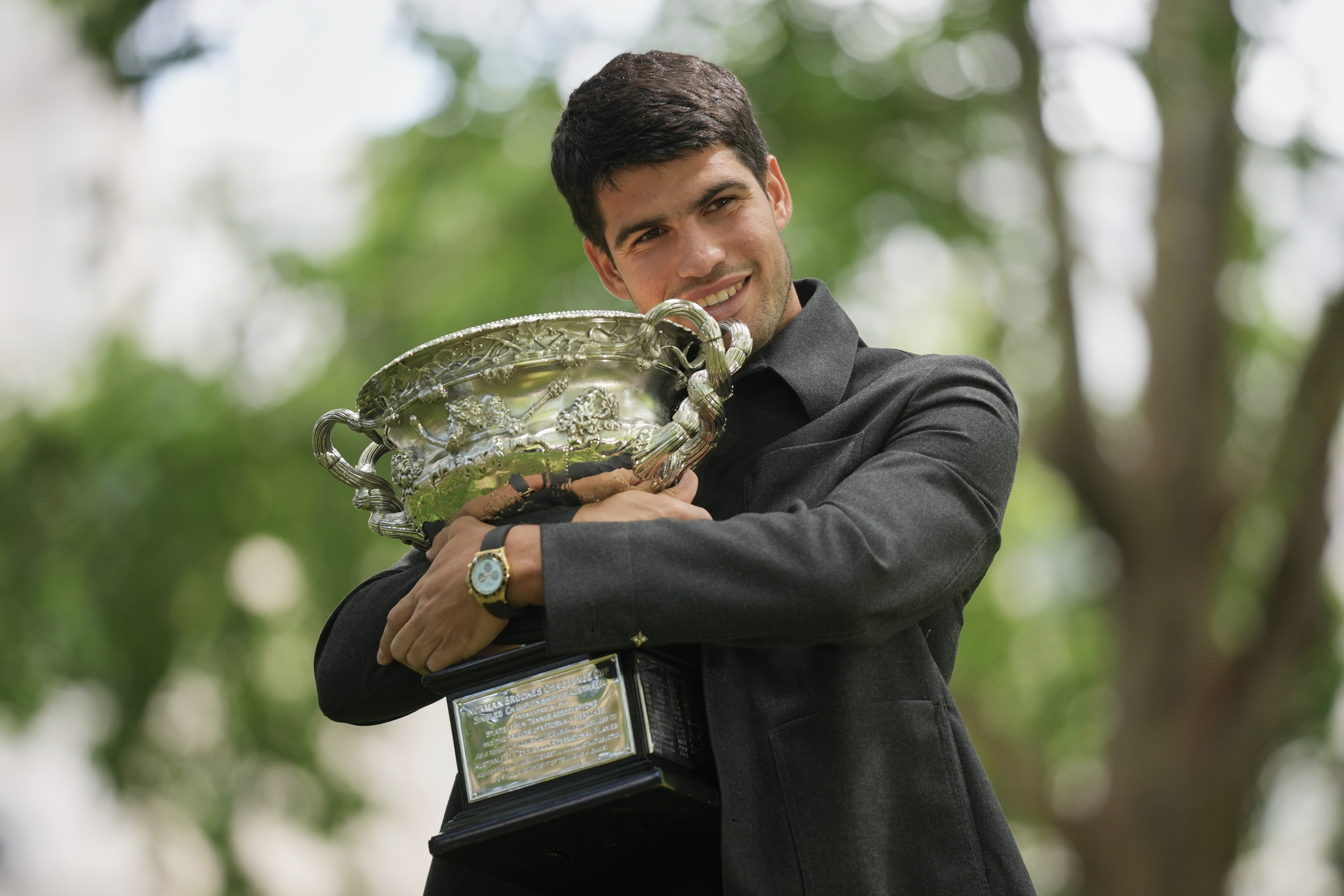 Carlos Alcaraz of Spain holds the Norman Brookes Challenge Cup the morning after defeating Novak Djokovic of Serbia in the men's singles final at the Australian Open tennis championship, in Melbourne, Australia, Monday, Feb. 2, 2026. (AP Photo/Dita Alangk