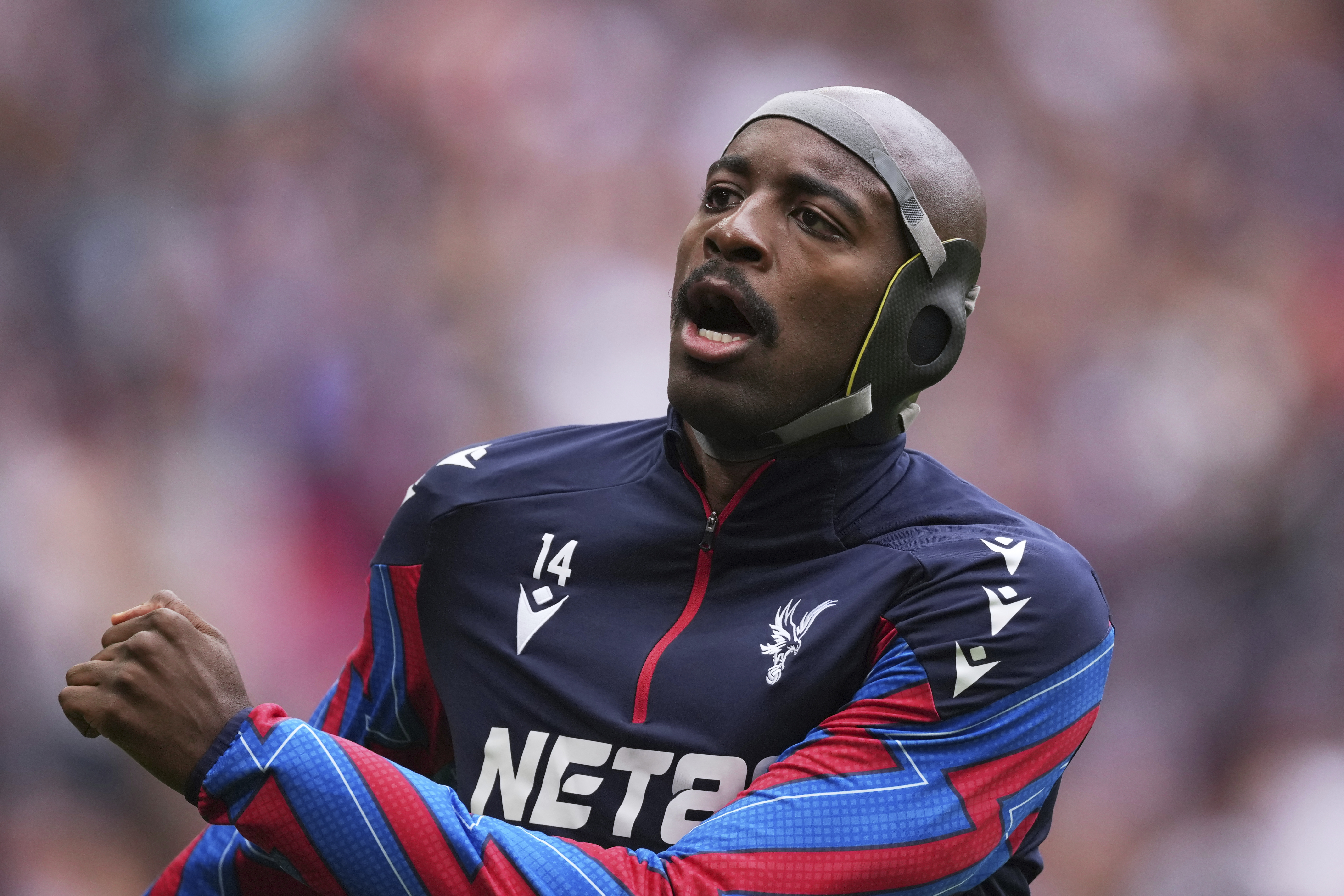 Crystal Palace's Jean-Philippe Mateta, wearing protective headgear, warms up before the English FA Cup semifinal soccer match between Crystal Palace and Aston Villa at the Wembley stadium in London, Saturday, April 26, 2025. (AP Photo/Dave Shopland)