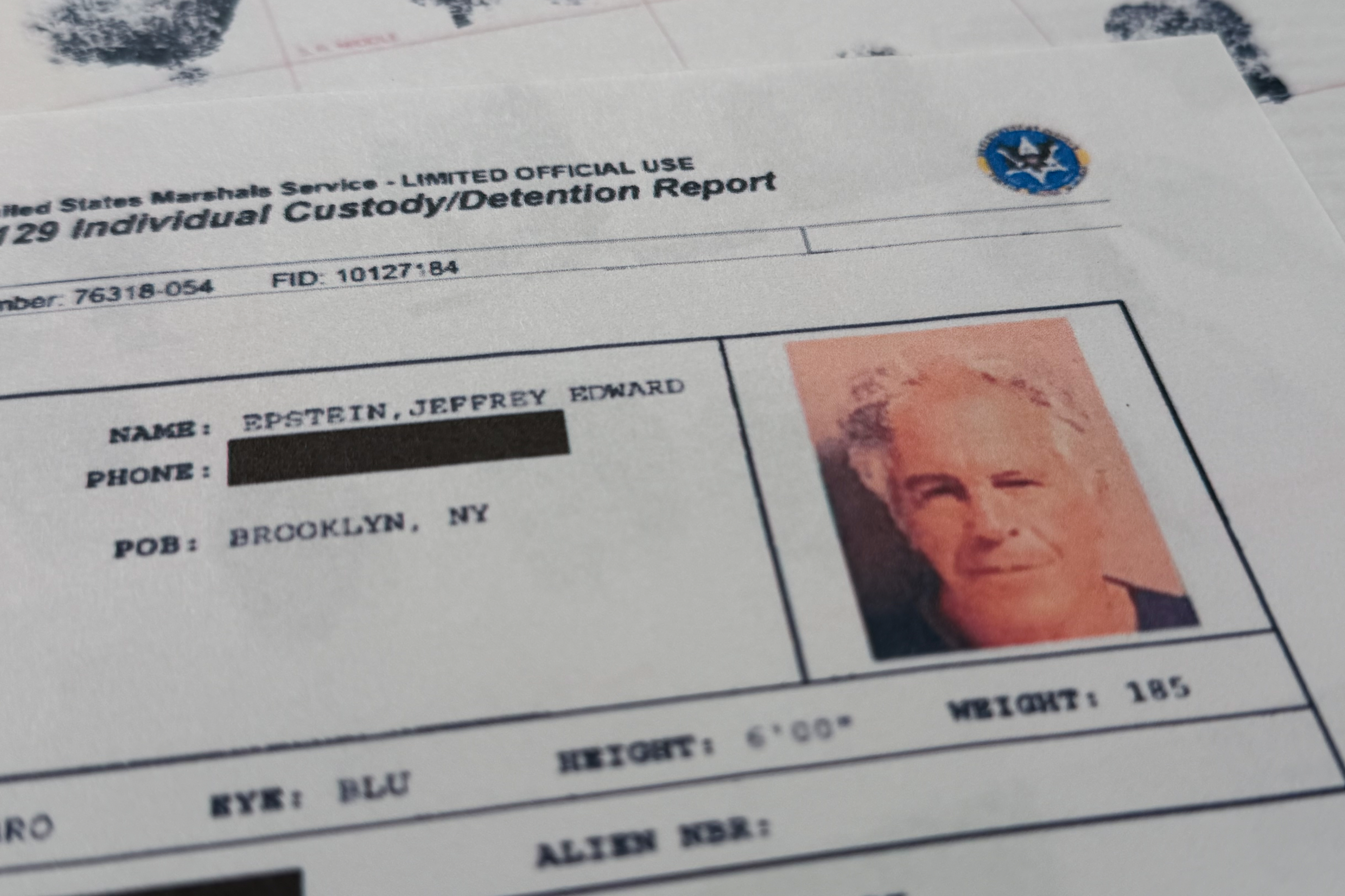 A document that was included in the U.S. Department of Justice release of the Jeffrey Epstein files is photographed Sunday, Feb. 1, 2026, shows the report when Epstein was taken into custody on July 6, 2019. (AP Photo/Jon Elswick)