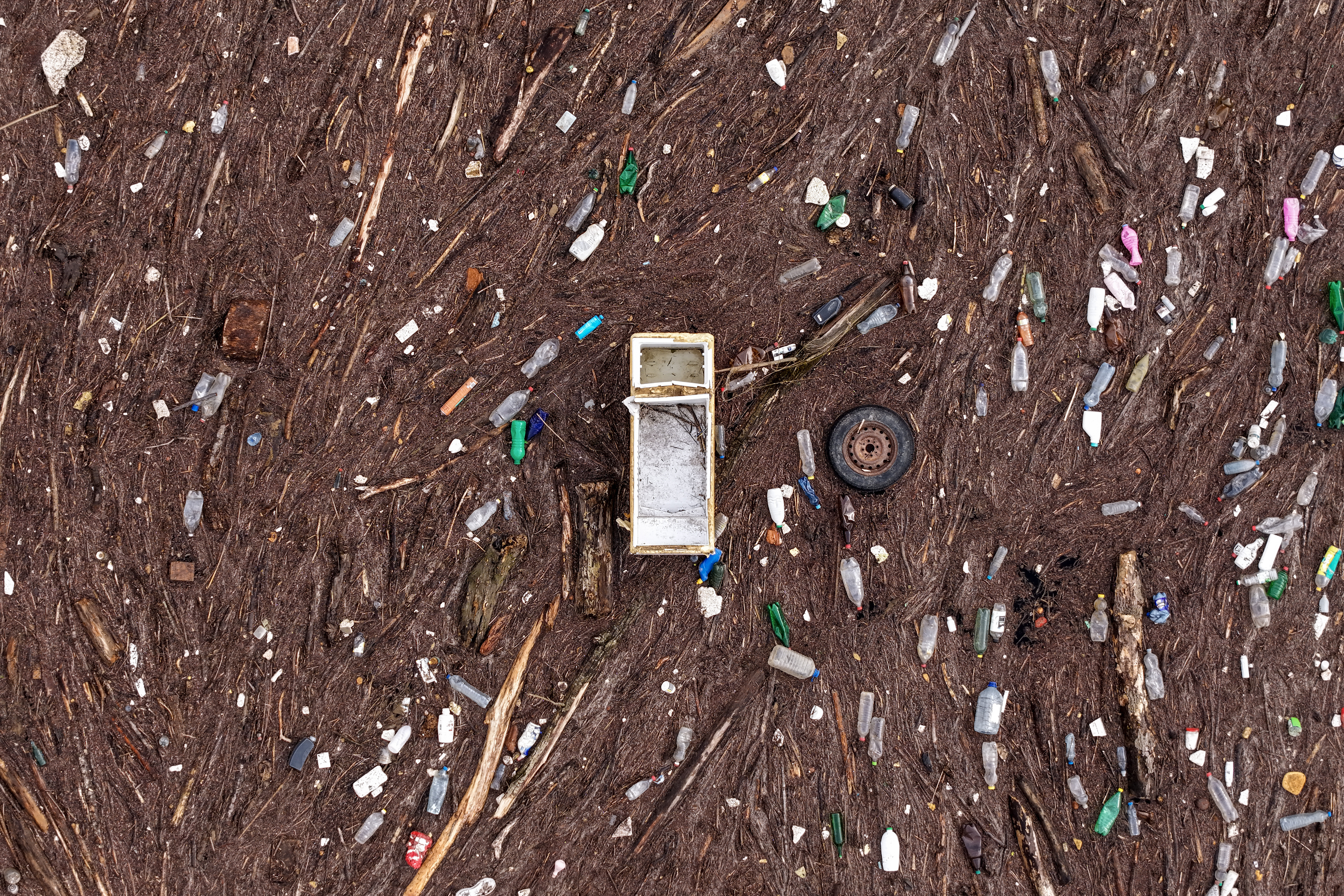 An aerial view shows a fridge and a car tire amongst other waste clogging the Drina river in Visegrad, Bosnia, Thursday, Feb. 5, 2026. (AP Photo/Armin Durgut)