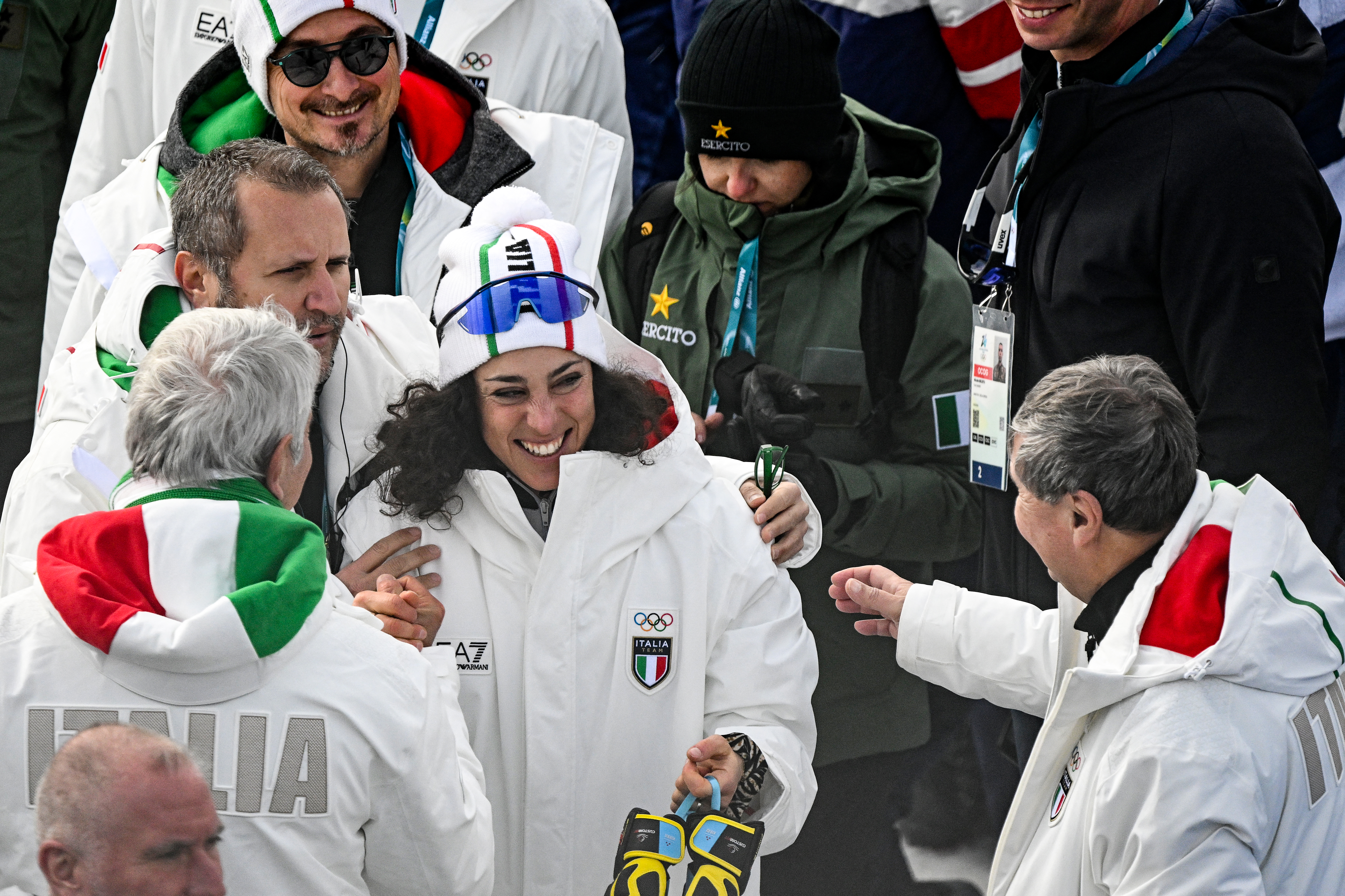 Gold medallist Italy's Federica Brignone celebrates with team members after the women'