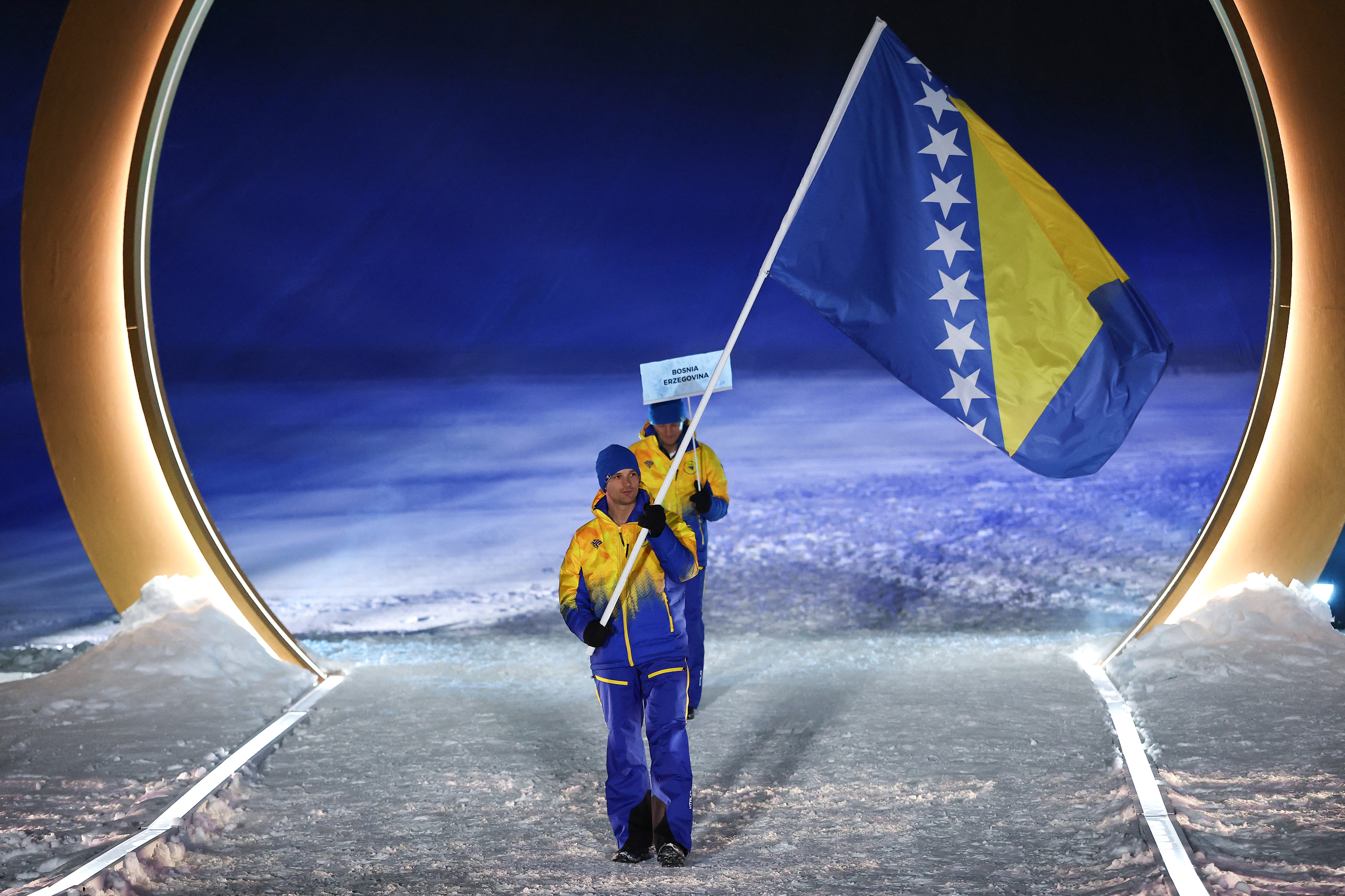 Bosnia and Herzegovina's flag bearer Marko Sljivic enters the parade during the opening ceremony of the Milano Cortina 2026 Winter Olympic Games in Livigno, northern Italy, on February 6, 2026. (Photo by Cameron Spencer / POOL / AFP)