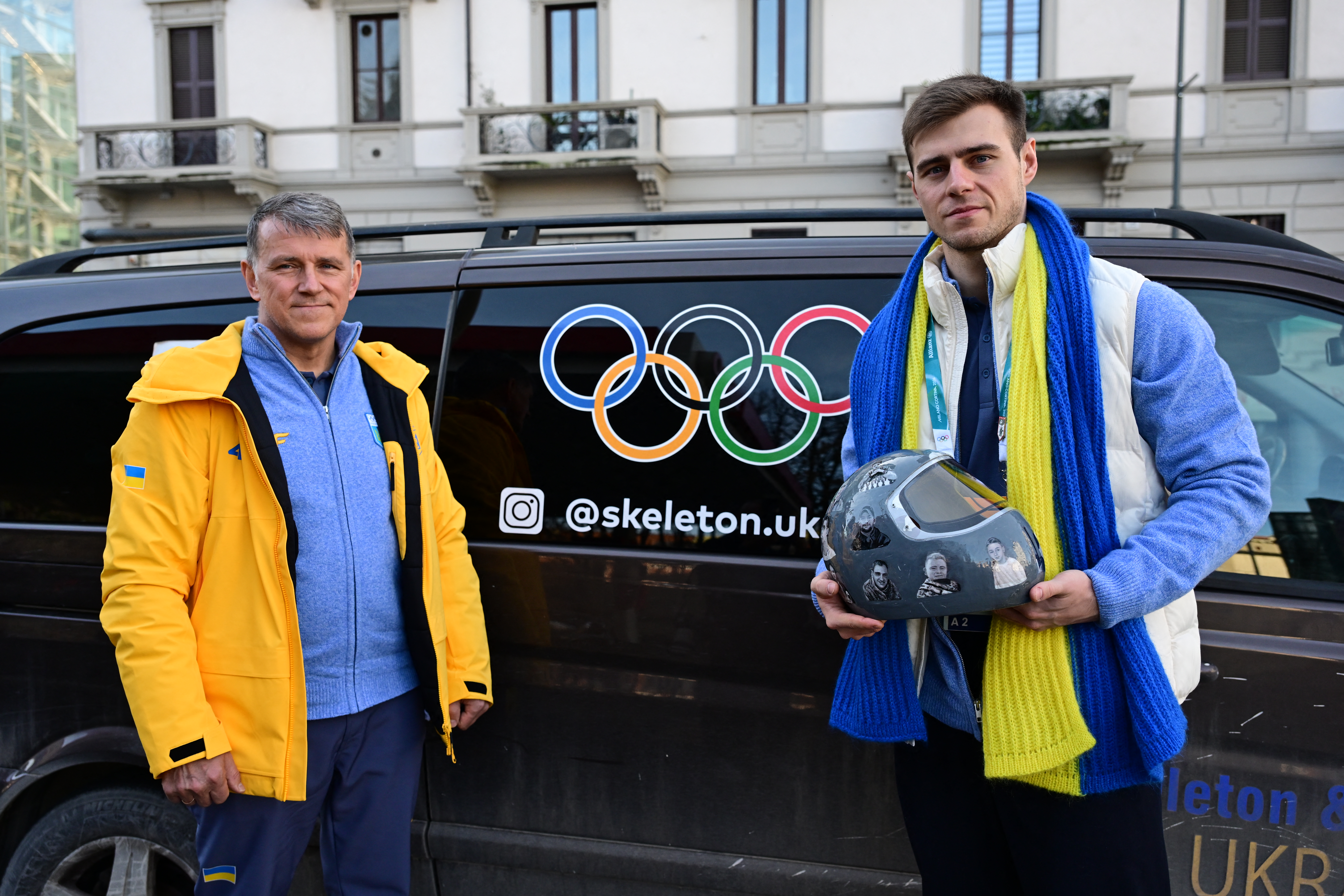 Ukrainian skeleton athlete Vladyslav Heraskevych poses with his helmet next to