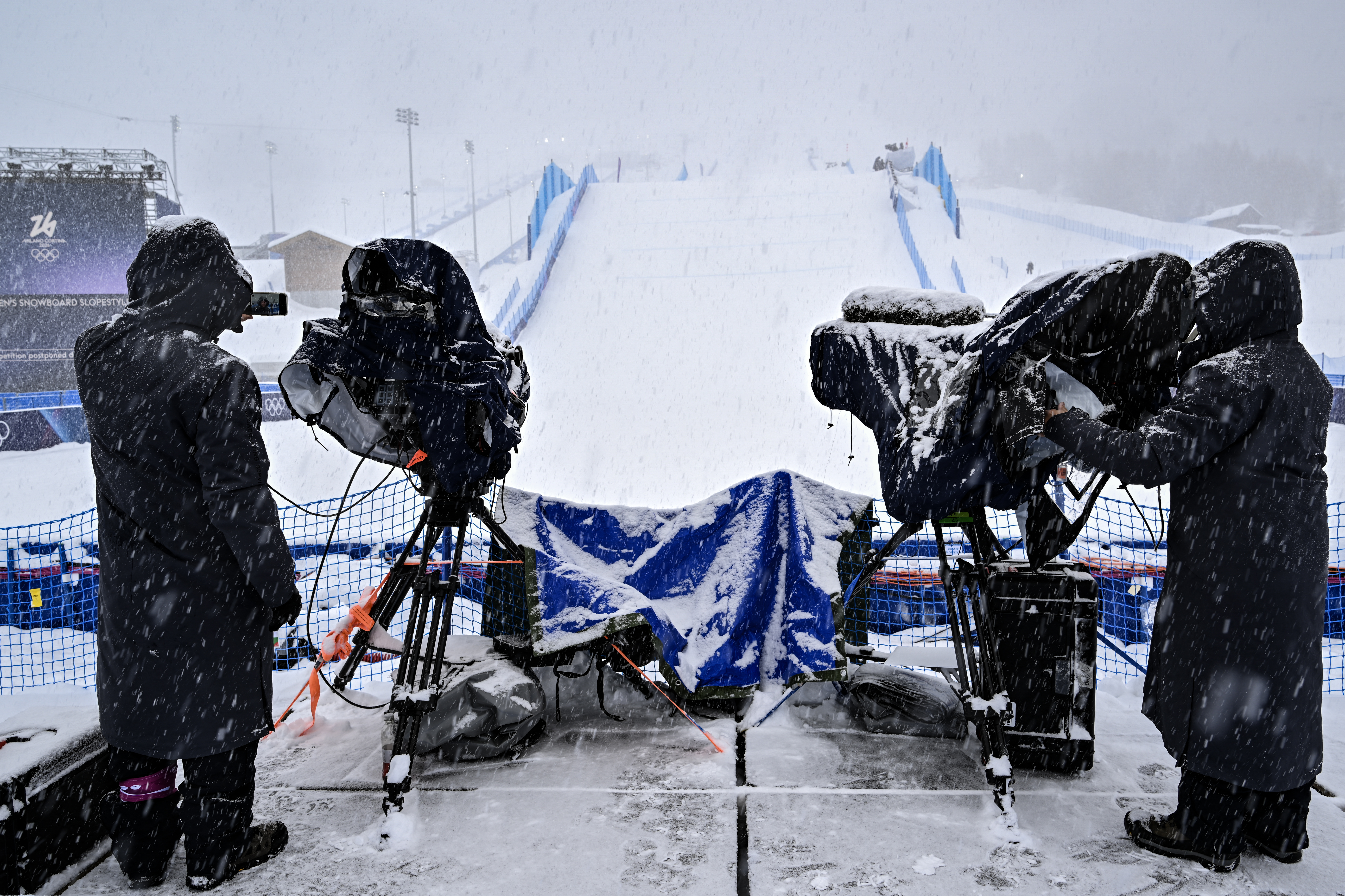 Broadcast camera operators man their positions despite the cancellation due
