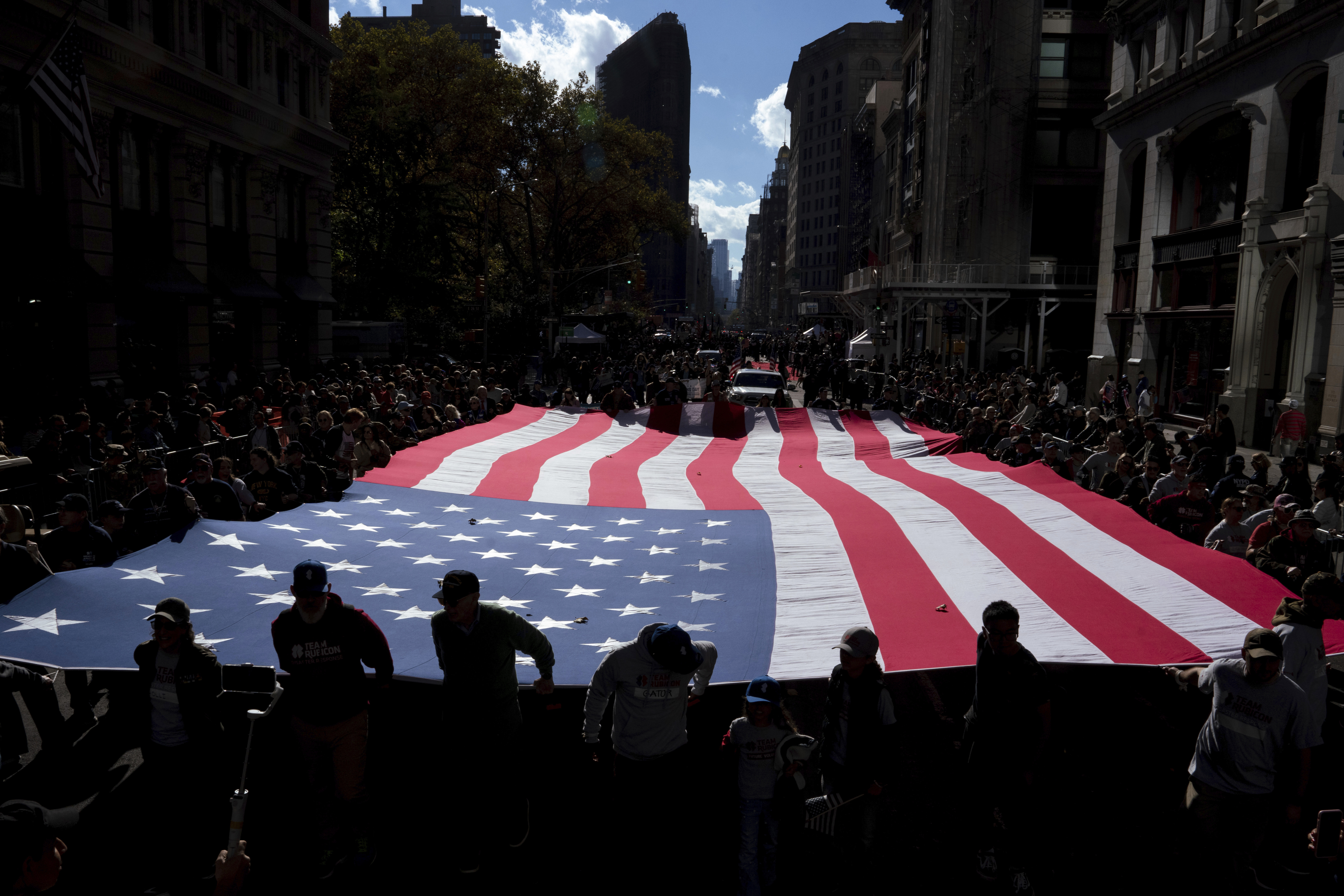 People carry the American flag during the annual Veterans Day Parade, Monday, Nov. 11, 2024, in New York. (AP Photo/Adam Gray)