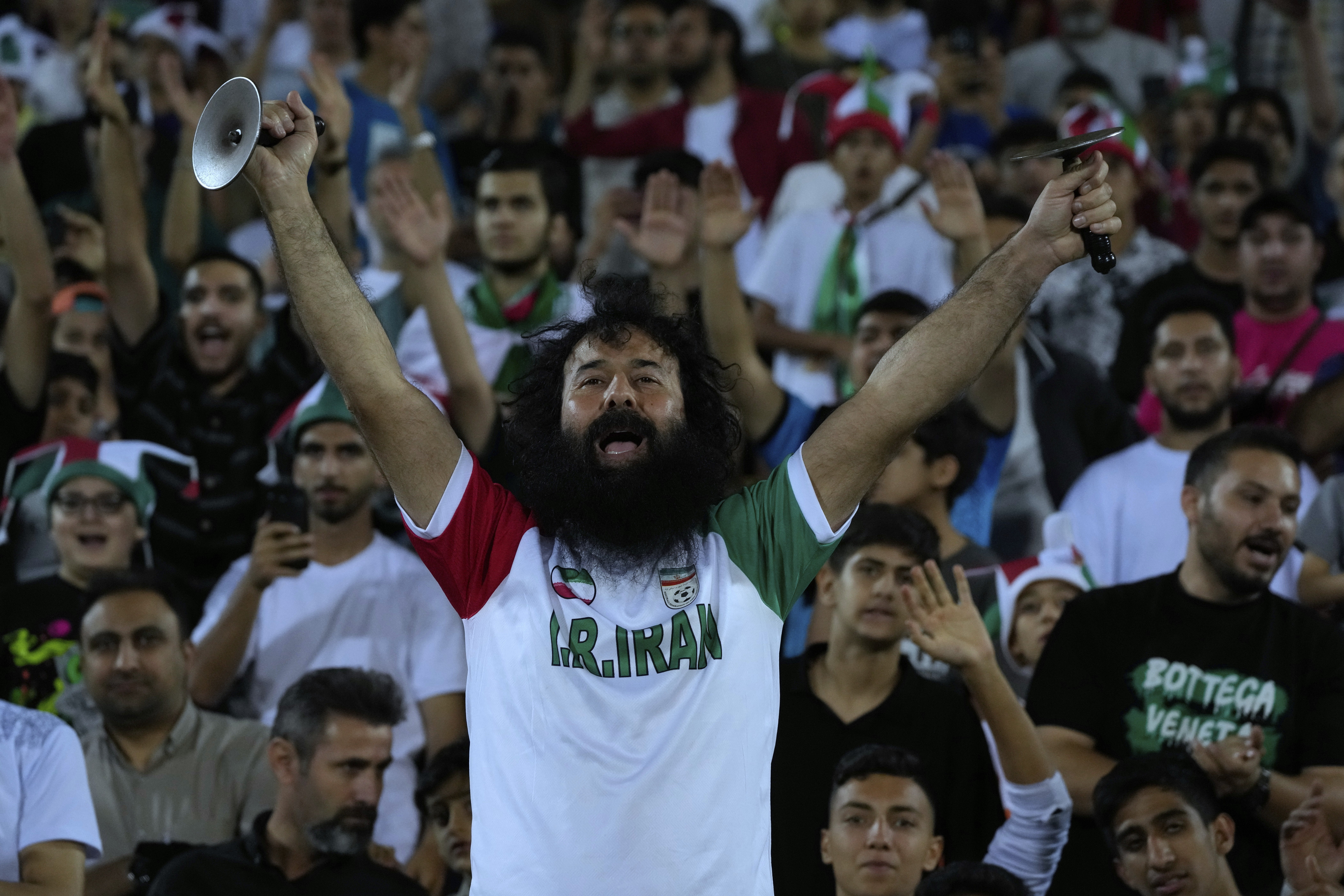 An Iranian fans' leader celebrates after Iran defeated North Korea during their Asian qualifier group A soccer match for 2026 World Cup, at Azadi Stadium in Tehran, Iran, Tuesday, June 10, 2025. (AP Photo/Vahid Salemi)