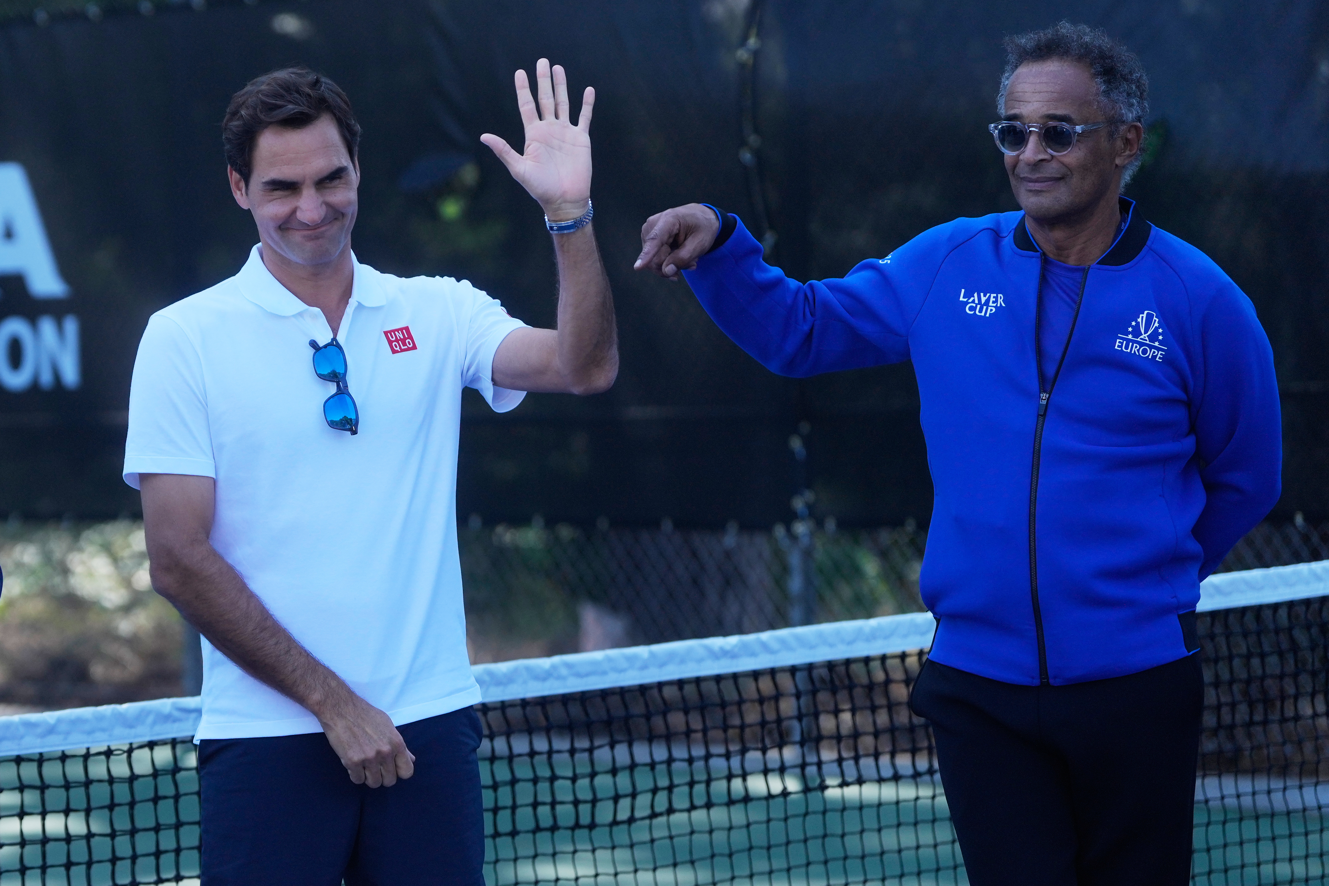 Co-creator of the Laver Cup Roger Federer, left, waves next to Team Europe Captain Yannick Noah before meeting with local youth tennis players from Youth Tennis Advantage at John McLaren Park Tennis Courts before the Laver Cup tennis matches in San Franci