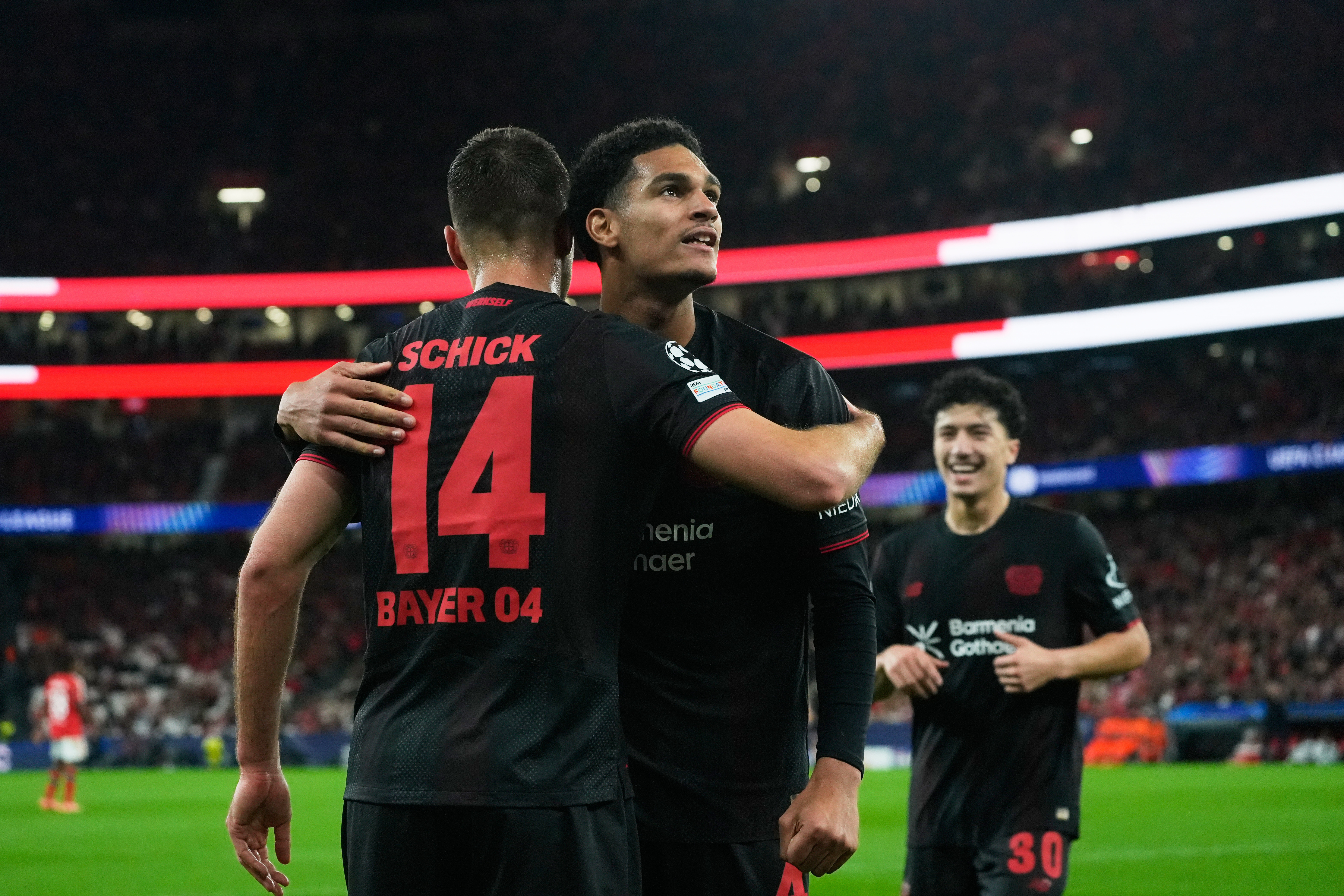Leverkusen's Patrik Schick celebrates with Jarell Quansah after scoring the opening goal during a Champions League opening phase soccer match between SL Benfica and Bayer 04 Leverkusen, in Lisbon, Wednesday, Nov. 5, 2025. (AP Photo/Ana Brigida)
