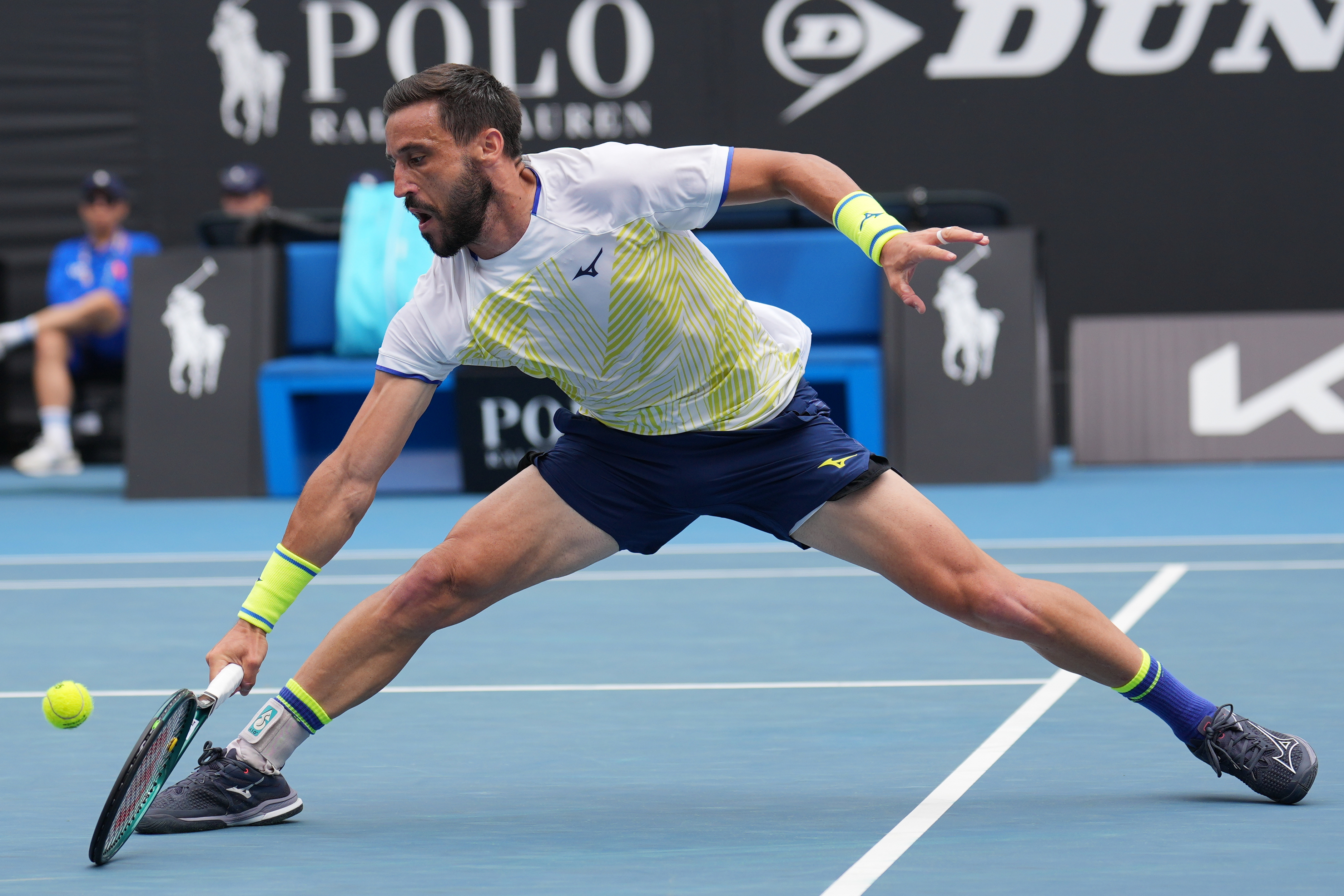 Damir Dzumhur of Bosnia and Herzegovina plays a backhand return to Francisco Cerundolo of Argentina during their second round match at the Australian Open tennis championship in Melbourne, Australia, Wednesday, Jan. 21, 2026. Džumhur
