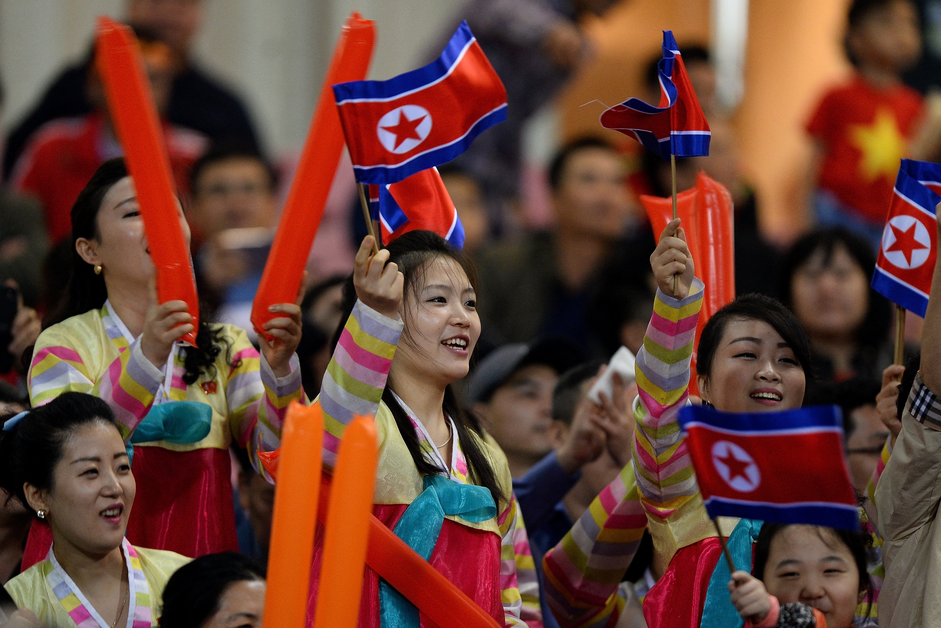 North Korean fans cheer before the start of the friendly football match between Vietnam and North Korea at the My Dinh Stadium in Hanoi on December 25, 2018. (Photo by Nhac NGUYEN / AFP)