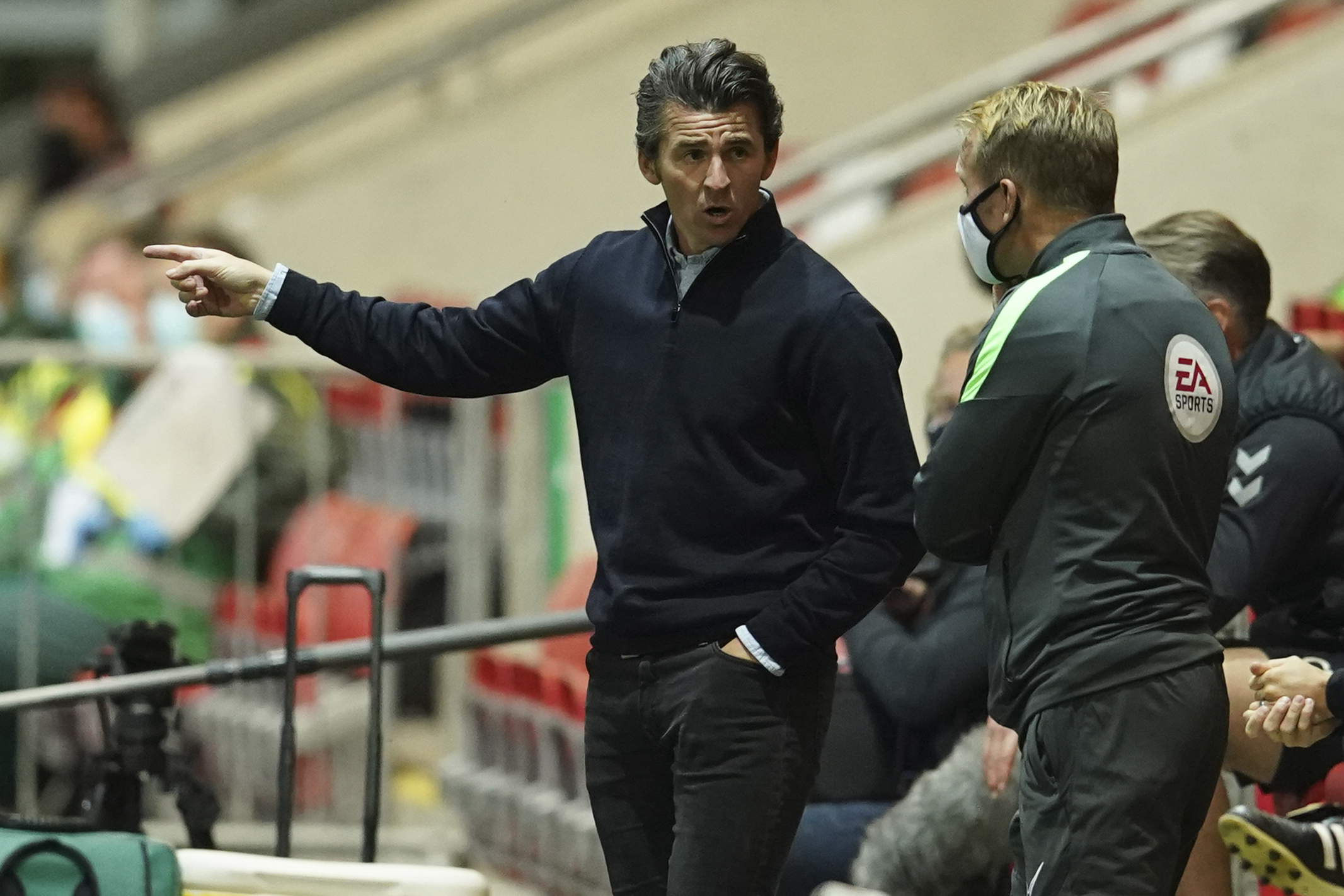 Fleetwood Town's manager Joey Barton, center, talks to an official during the English League Cup third round soccer match between Fleetwood Town and Everton at the Highbury Stadium in Fleetwood, England, Wednesday, Sept. 23, 2020. (Dave Thompson/Pool via