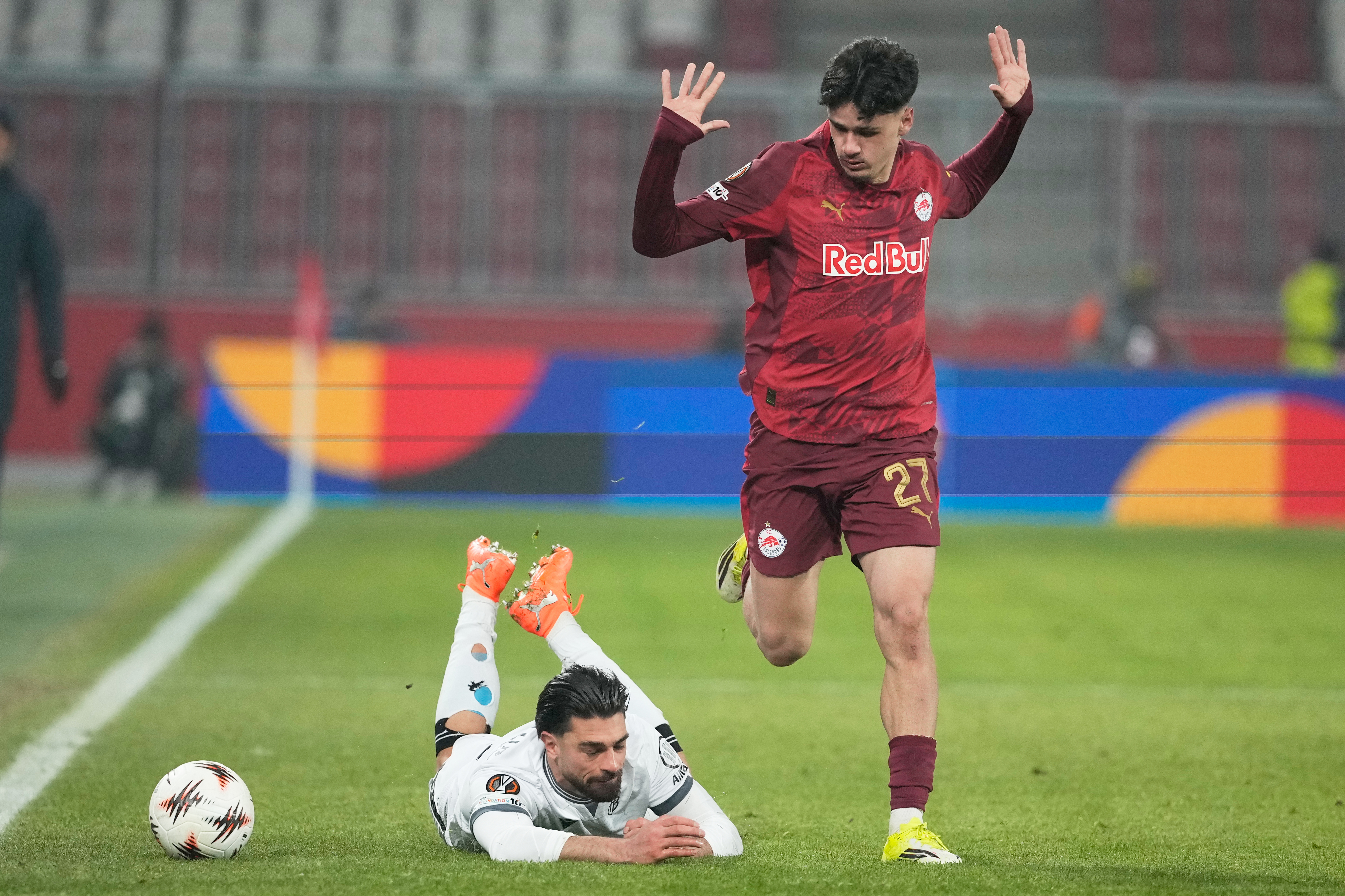 Basel's Nicolas Vouilloz, bottom, and Salzburg's Kerim Alajbegovic in action during the Europa League opening phase soccer match between FC Salzburg and Basel in Salzburg, Austria, Thursday, Jan. 22, 2026. Alajbegović