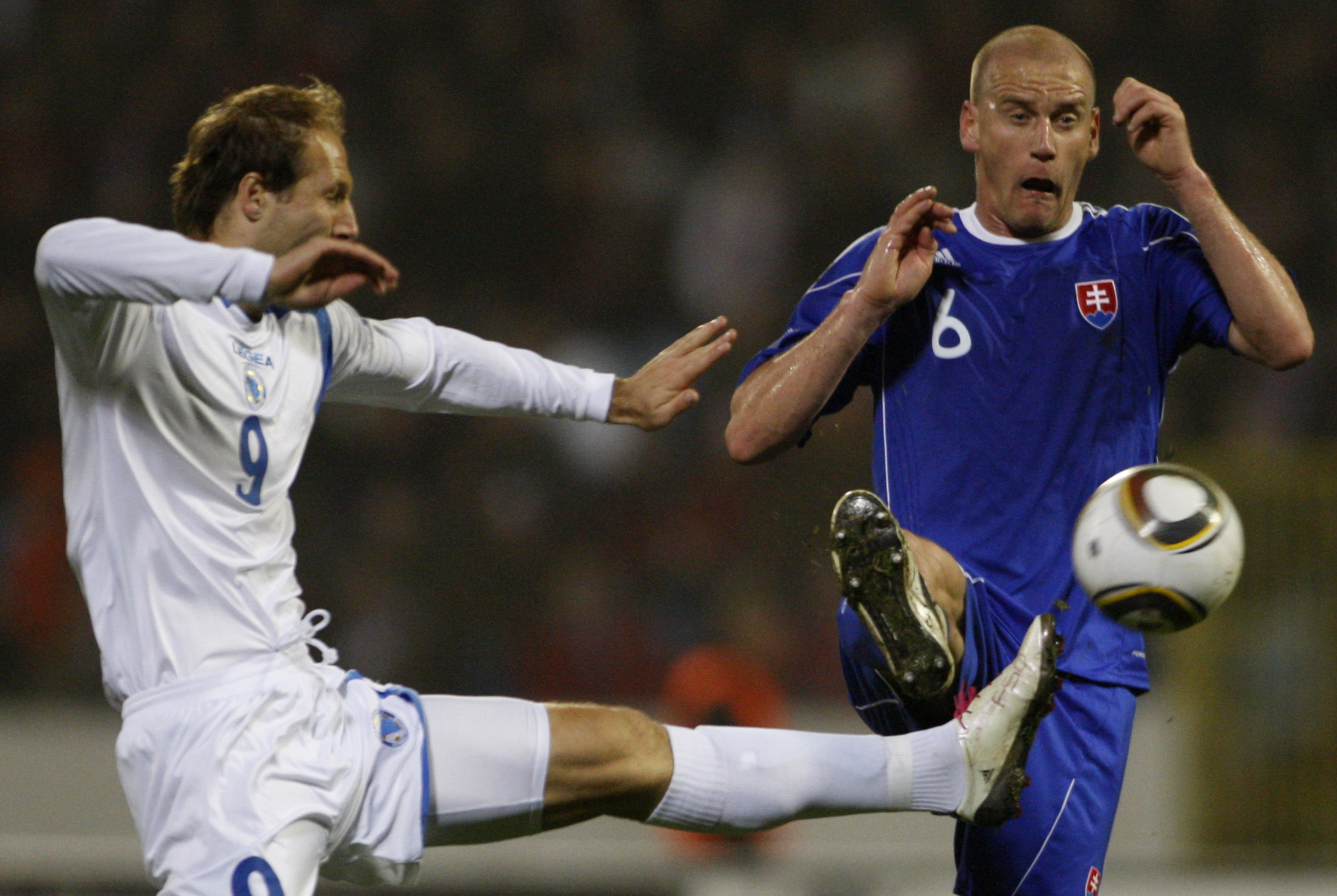 Miroslav Karhan, right, from Slovakia challenges for a ball Zlatan Muslimovic, left, from Bosnia-Herzegovina during their friendly soccer match in Bratislava, Slovakia, Wednesday, Nov. 17, 2010. (AP Photo/Petr David Josek)