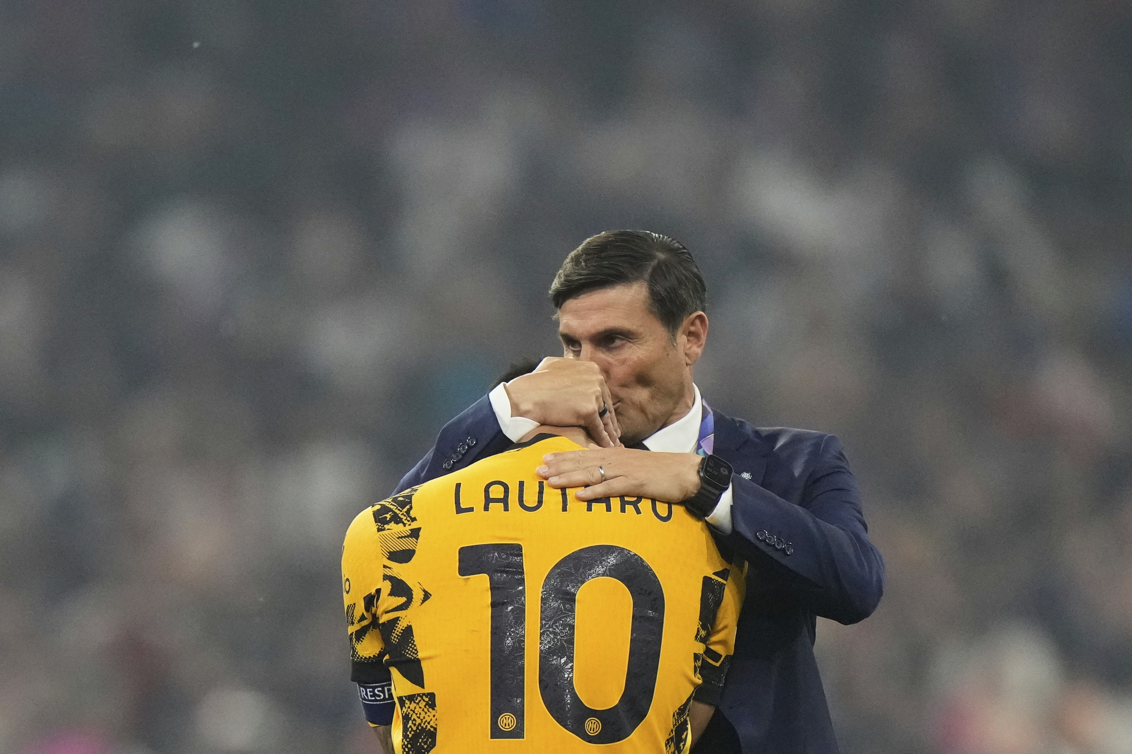 Former Inter Milan player Javier Zanetti, right, hugs Inter Milan's team captain Lautaro Martinez at the end of the Champions League final soccer match between Paris Saint-Germain and Inter Milan at the Allianz Arena in Munich, Germany, Saturday, May 31,