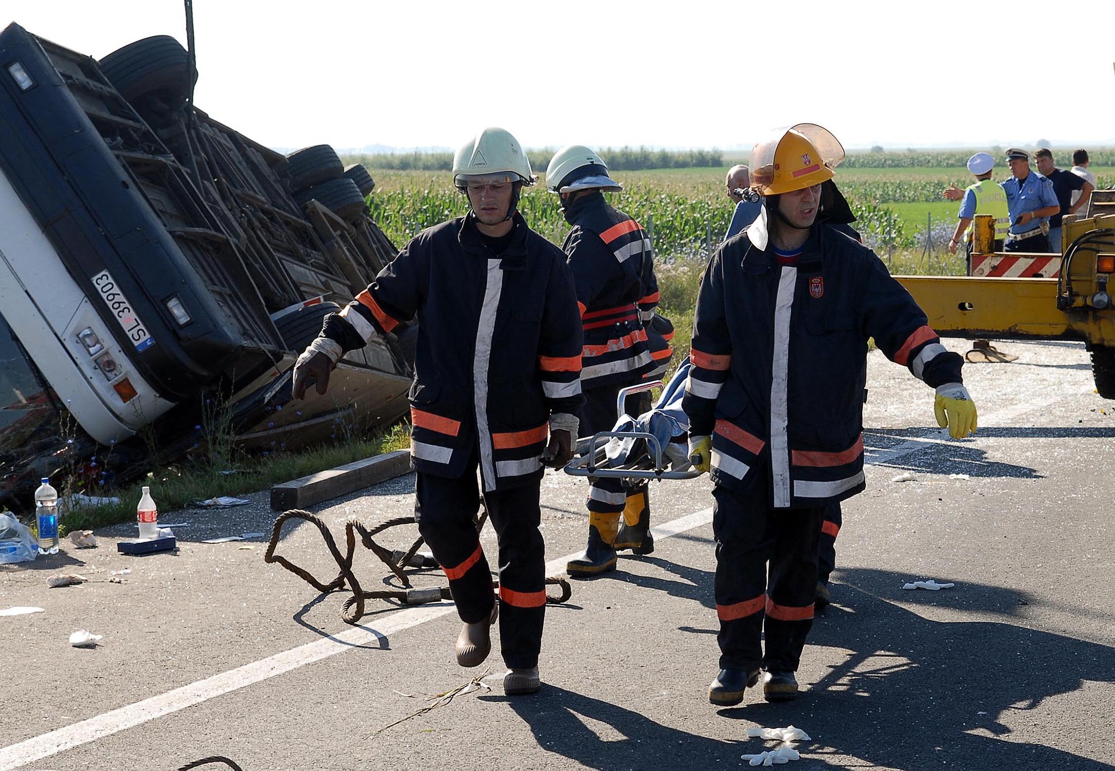Rescue workers carry the body of passenger after a tourist bus