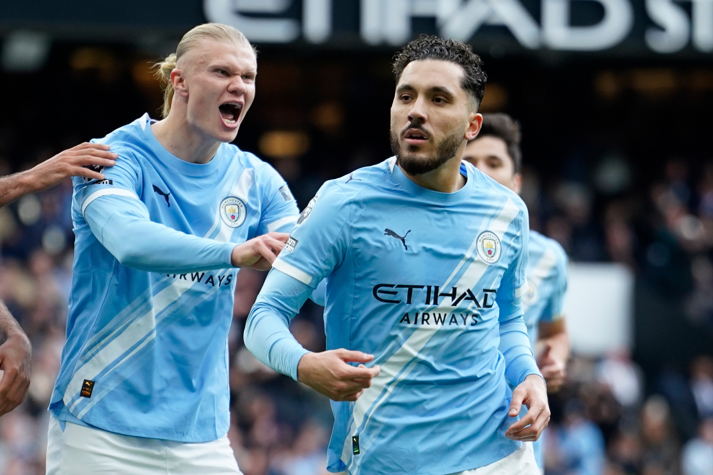 Manchester City's Rayan Cherki celebrates with his teammate Erling Haaland after scoring his side's first goal during the English Premier League soccer match between Manchester City and and Arsenal, in Manchester, England, Sunday, April 19, 2026. (AP Phot