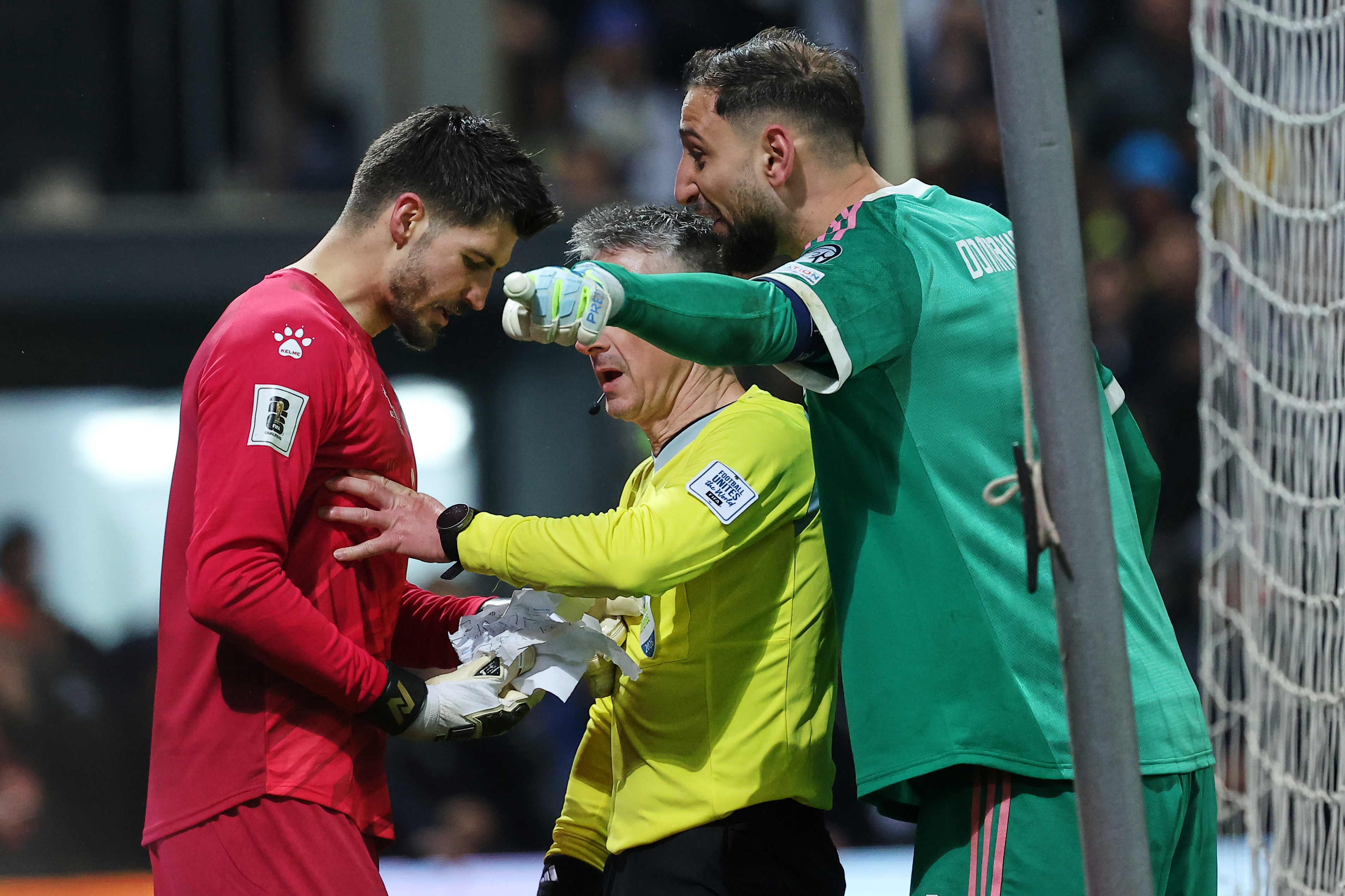 Bosnian goalkeeper Nikola Vasilj, left, and Italy goalkeeper Gianluigi Donnarumma argue during a penalty shootout during the World Cup qualifying playoff final soccer match between Bosnia and Italy in Zenica, Bosnia, Tuesday, March 31, 2026. (AP Photo/Arm