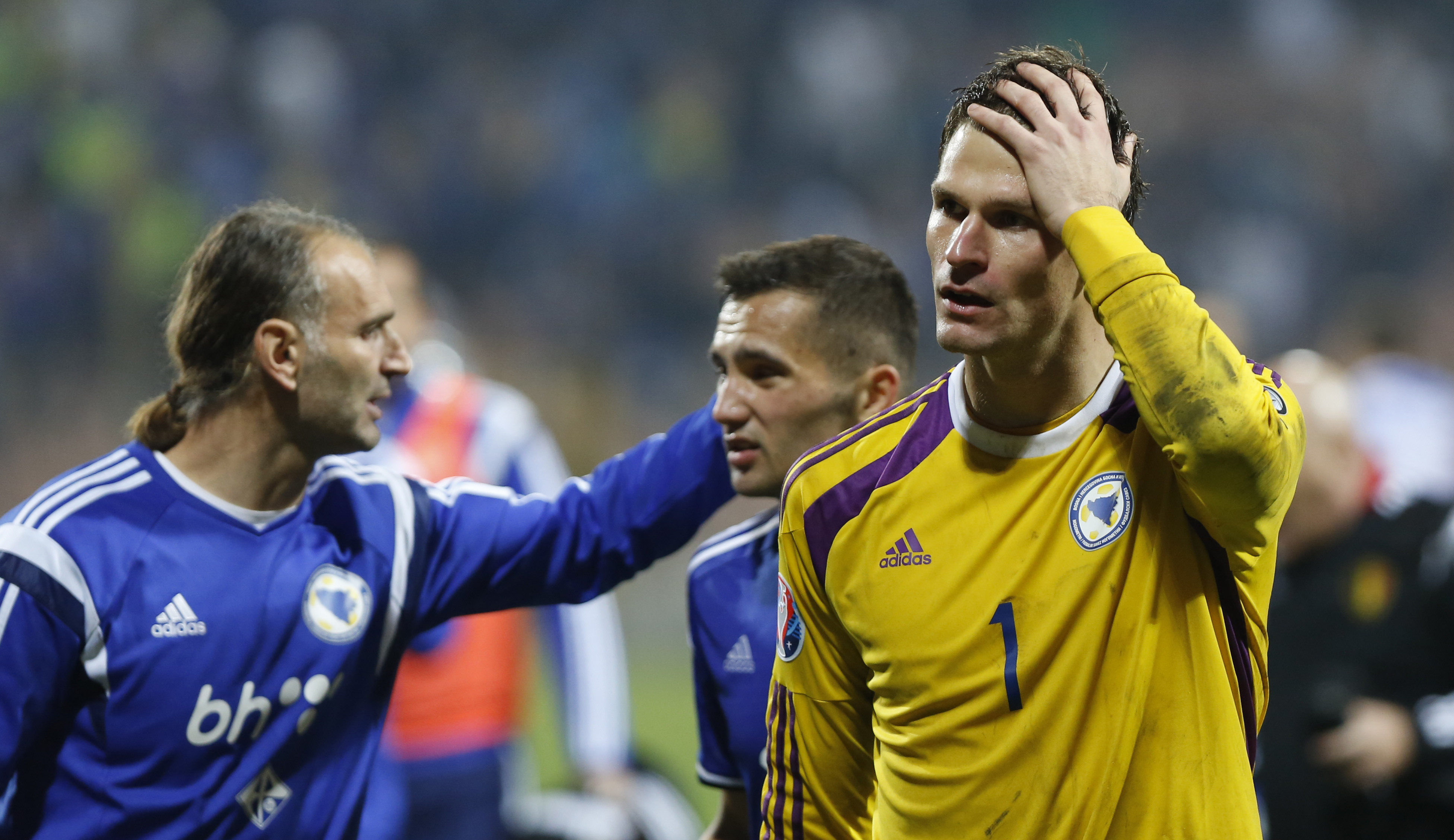 Bosnia's goalkeeper Asmir Begovic, right, leaves the pitch after the Euro 2016 Group B soccer qualifying match between Bosnia and Belgium at Stadium Bilino Polje in Zenica, Bosnia, Monday, Oct. 13, 2014. (AP Photo/Amel Emric)