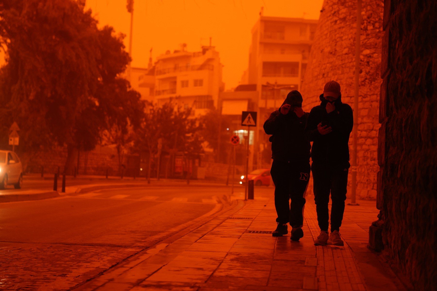 People cover themselves to protect from dust as Crete is cloaked by Saharan dust storm in Greece on April 1, 2026.